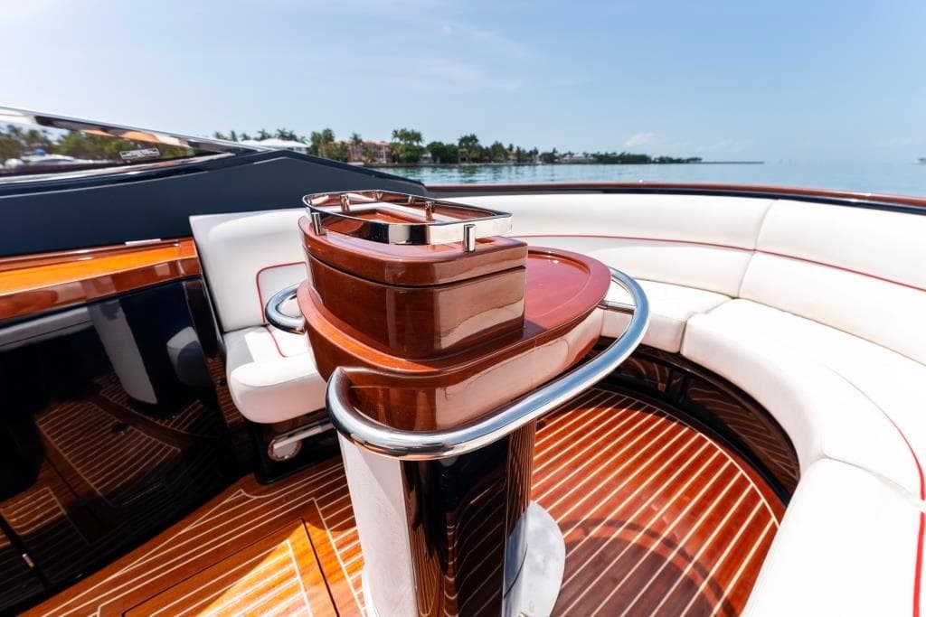 Interior of 2020 Riva Aquariva Super luxury yacht with polished wood and white seating.