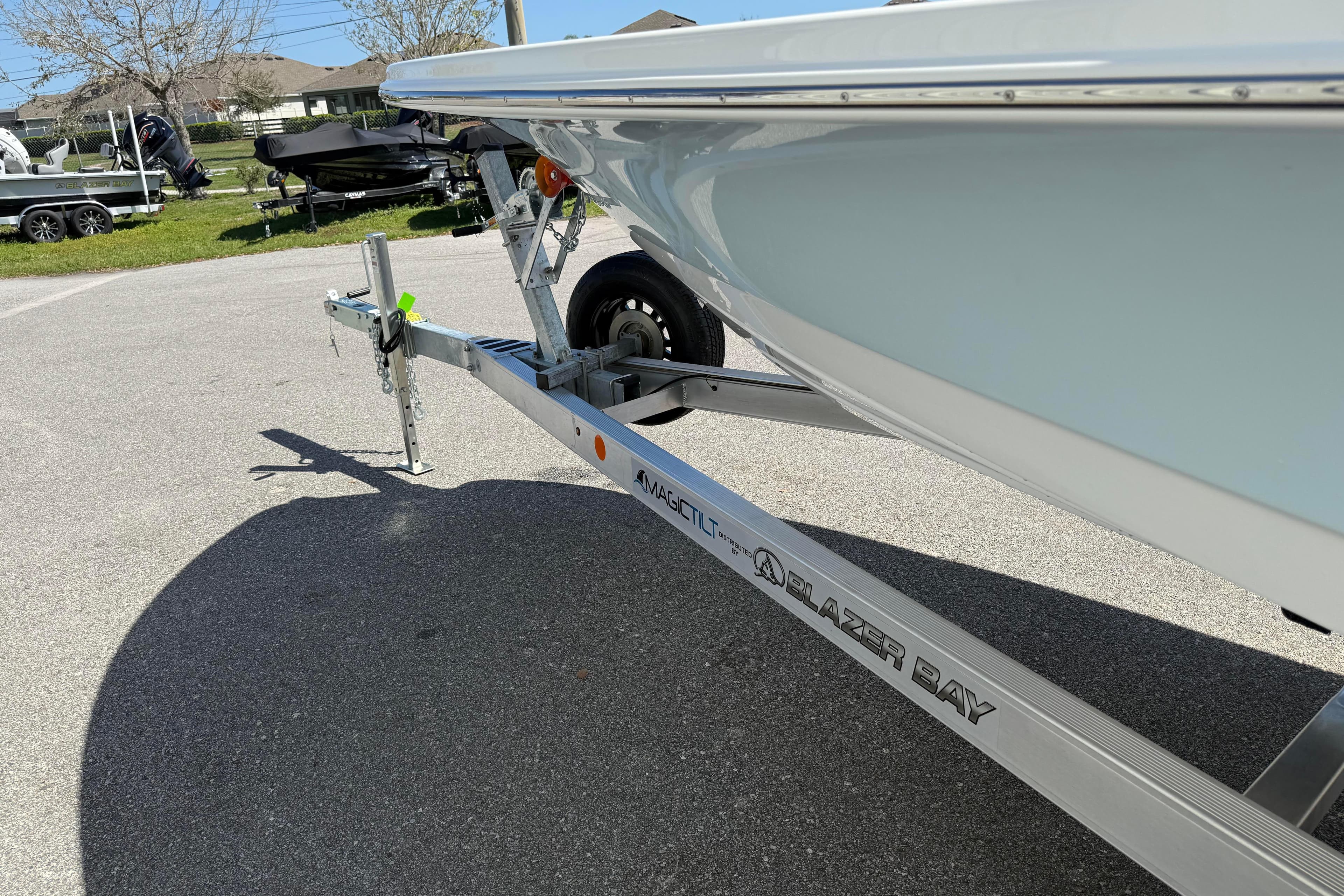2026 Blazer 2550 GTS boat on trailer, parked outdoors in sunny setting.