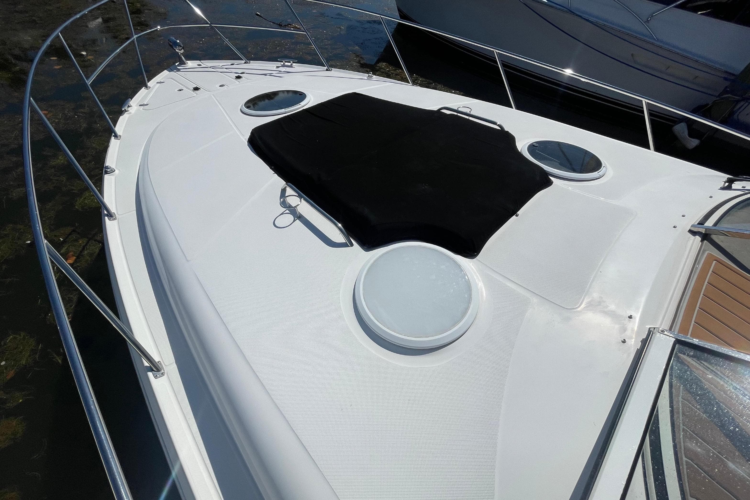 2006 Regal Commodore 3560 IB yacht deck with black cover and railing.