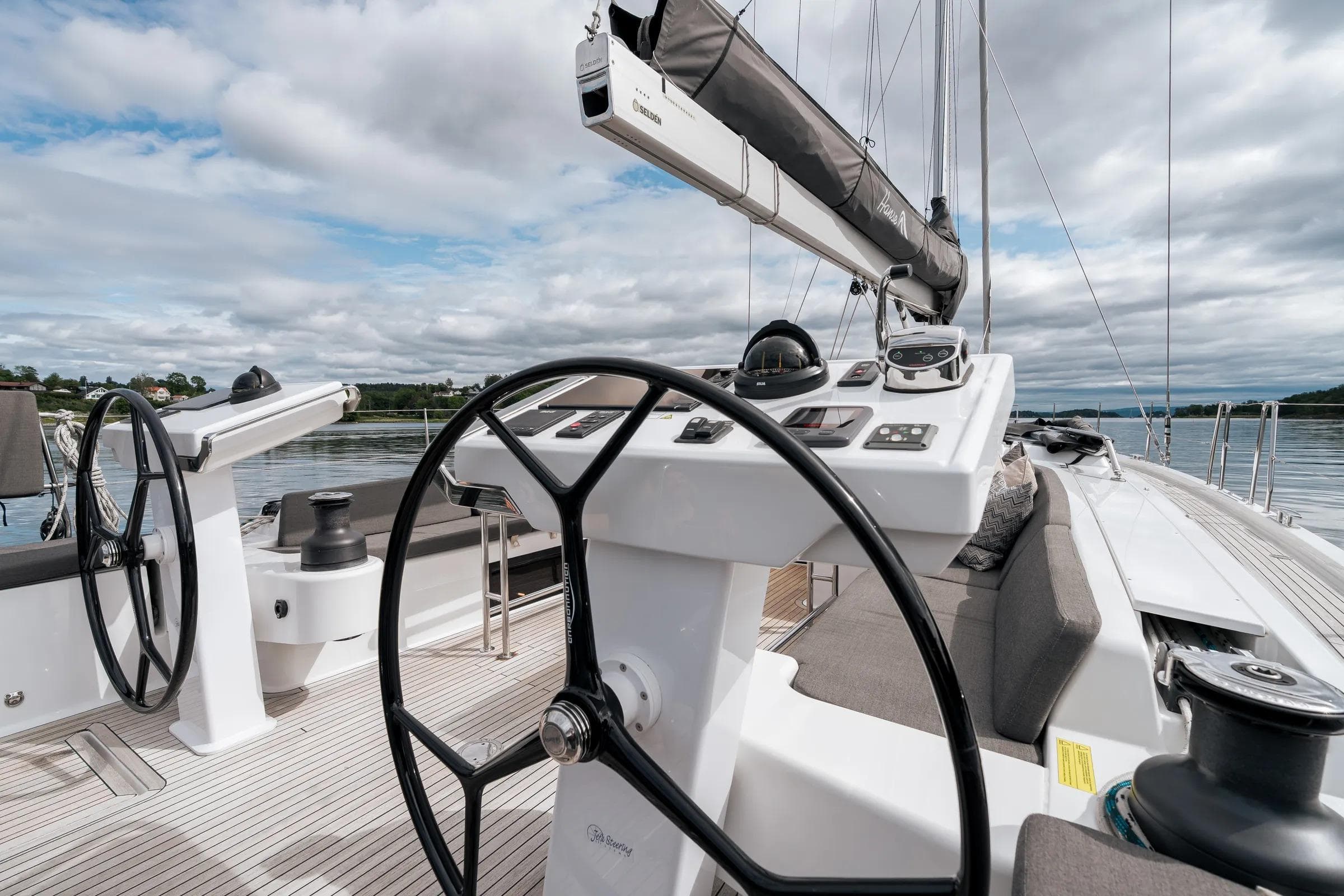 2019 Hanse 548 yacht cockpit with dual steering wheels and modern navigation equipment.