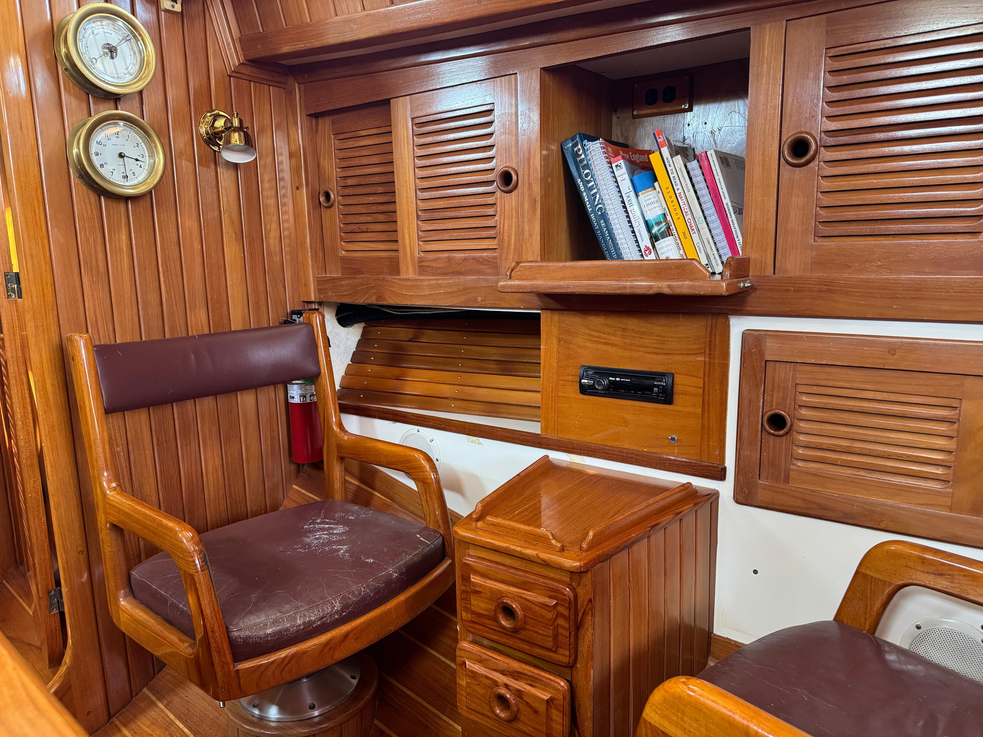 Interior of 1988 Cabo Rico 38XL sailboat with wooden cabinetry and seating.