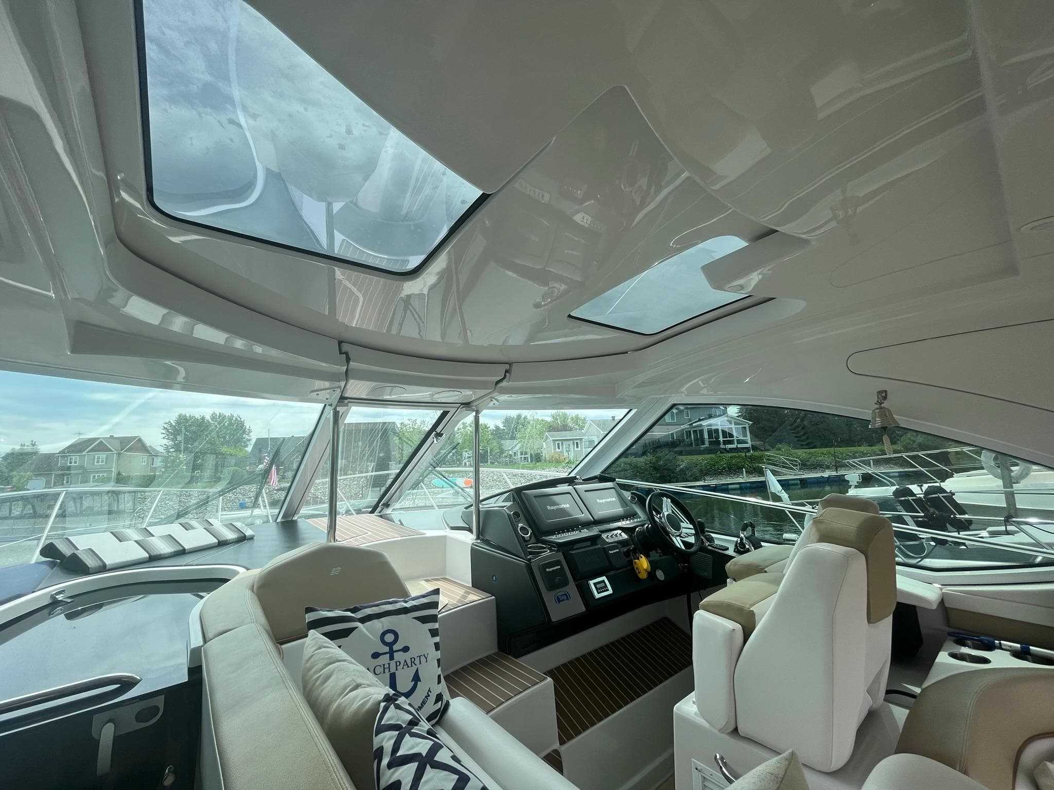 Interior of 2012 Four Winns V435 yacht with skylights and modern helm.
