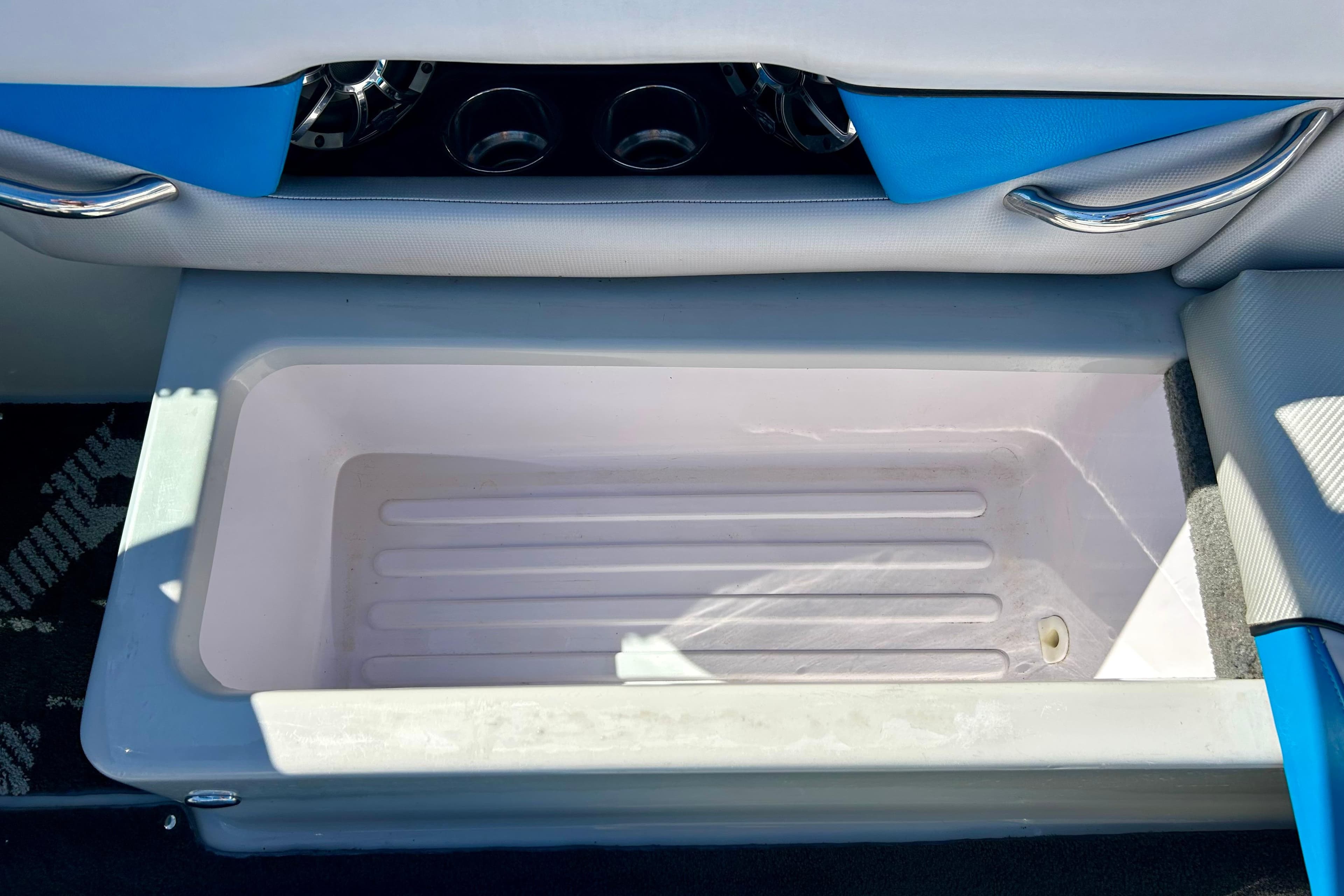 2012 Moomba Mojo 2.5 boat storage compartment with blue and white interior accents.
