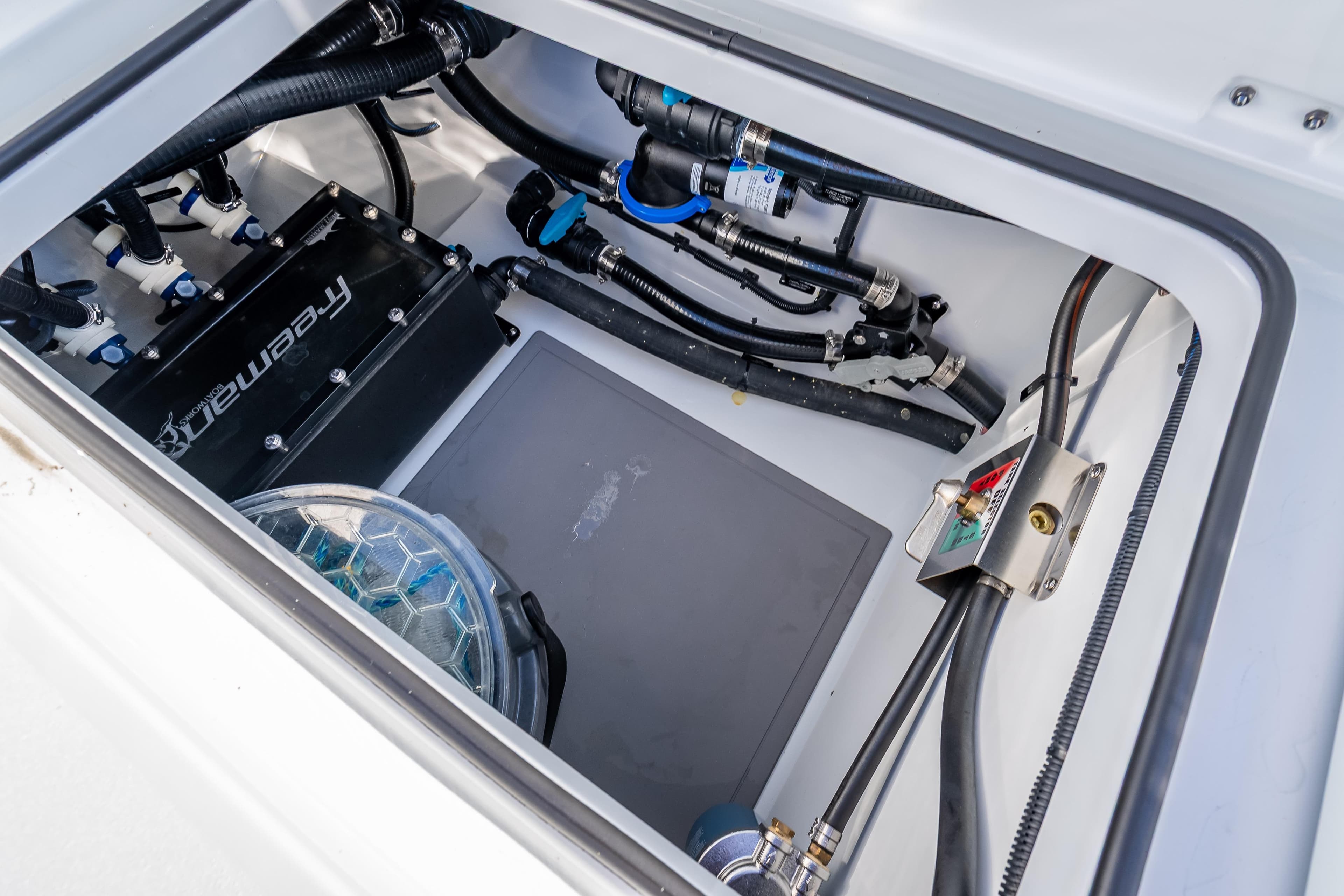 Engine compartment of 2026 Freeman 35 boat, showcasing wiring and components.