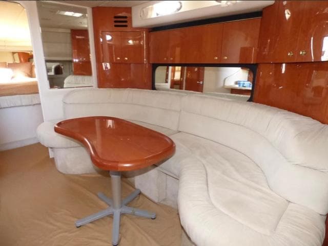 Luxurious interior of 1999 Sea Ray 380 Sundancer with plush seating and elegant wood finishes.