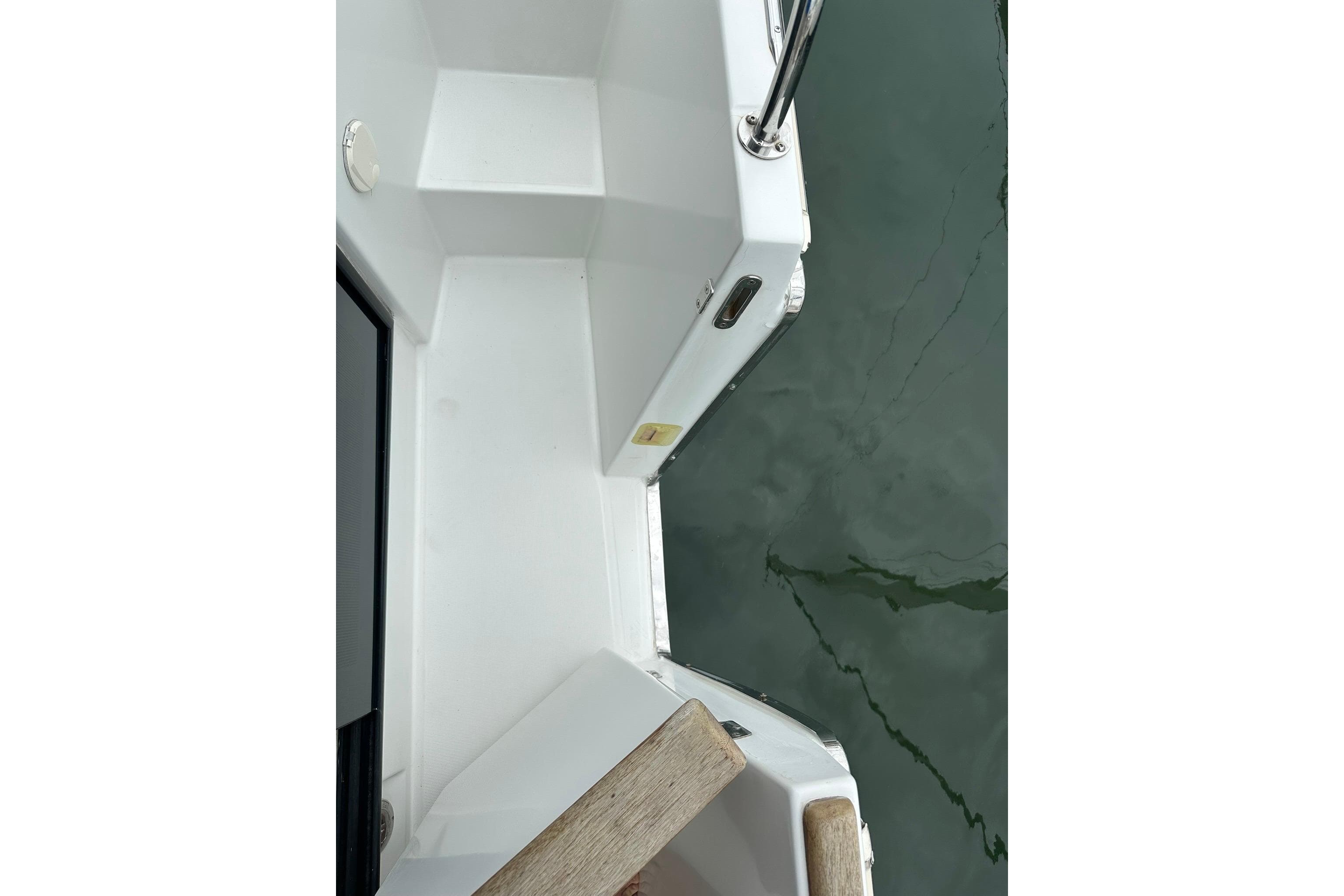 2011 Beneteau Swift Trawler 34 Fly deck view with railing and water reflection.