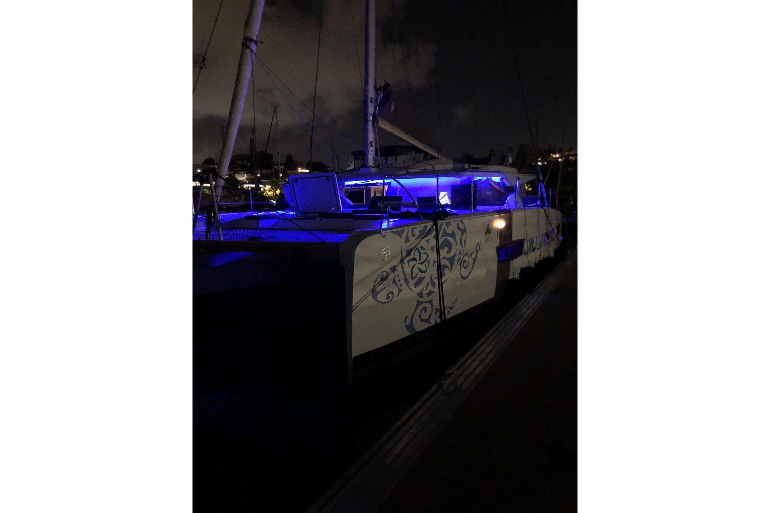 2021 Fountaine Pajot Catamaran Elba 45 illuminated at night with blue lights.