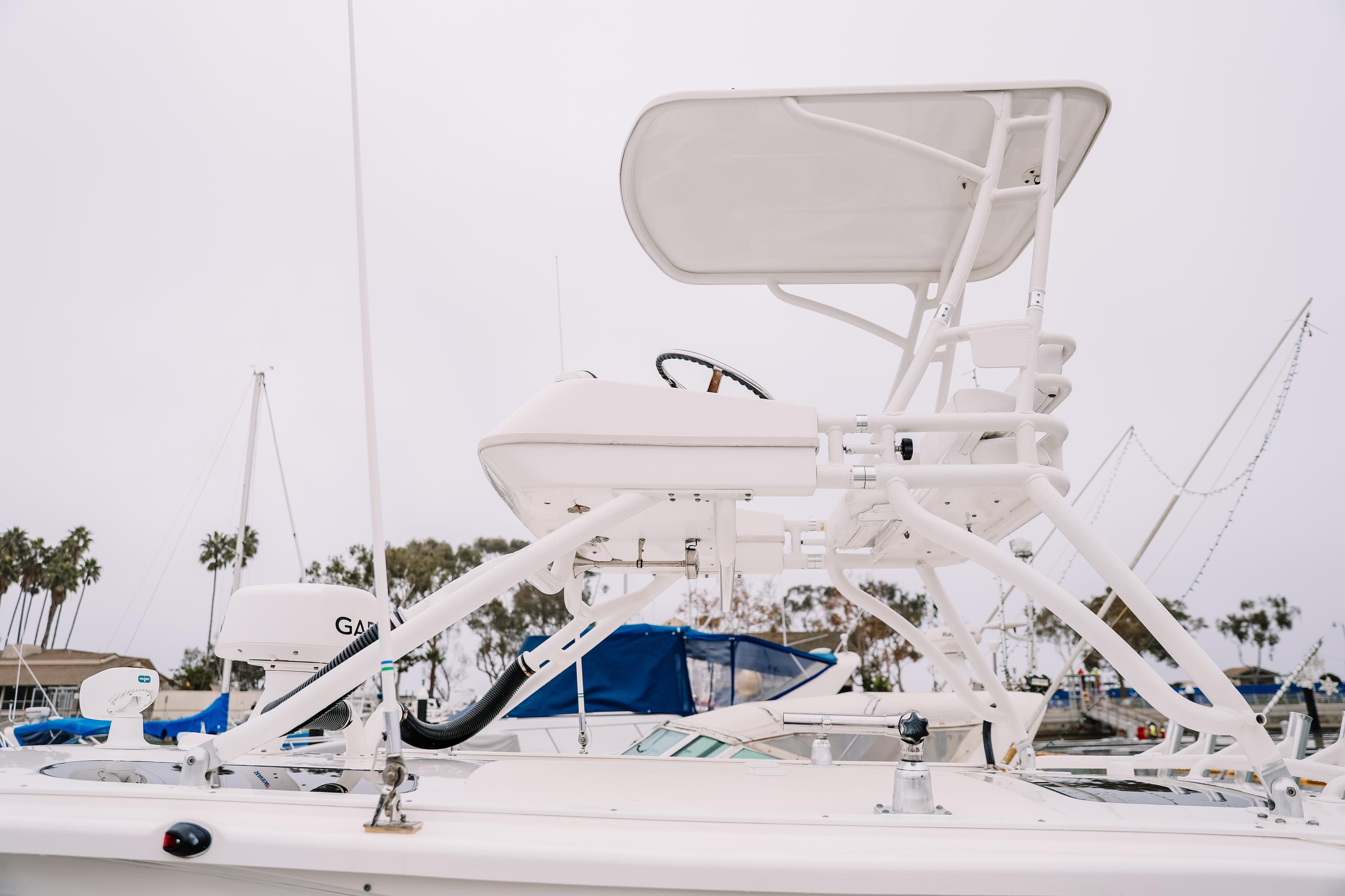 2010 Everglades 350LX boat with elevated helm station in marina setting.