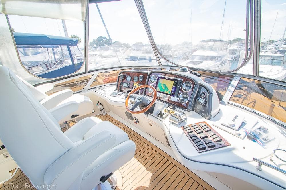 Helm of 2005 Sea Ray 420 Sedan Bridge with navigation equipment and luxurious seating.