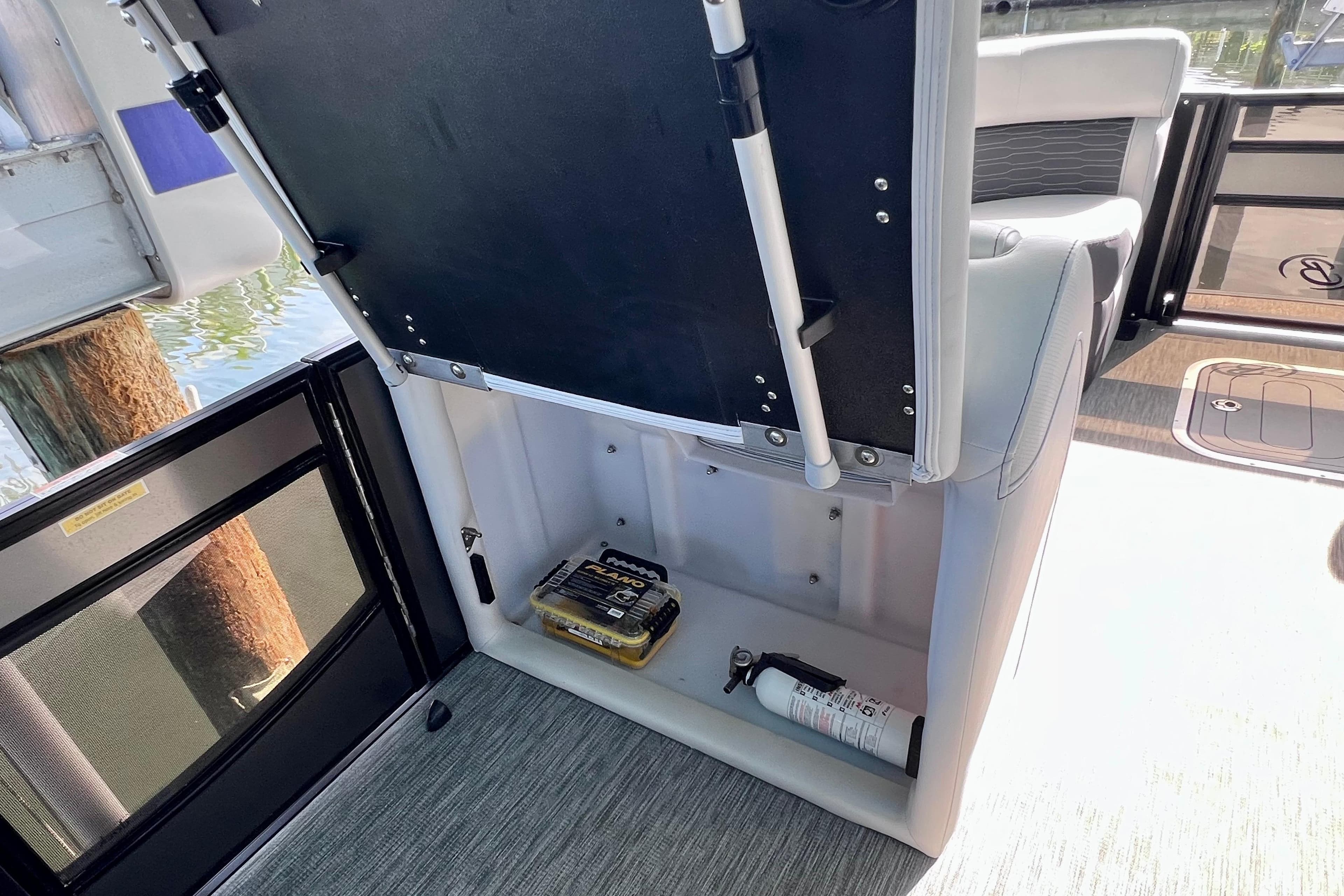 2023 Barletta Corsa 23UC boat storage compartment with safety equipment.