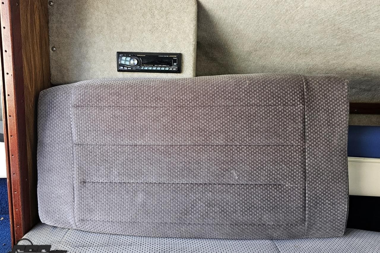 1988 Glastron/Carlson CVX-23 interior with gray upholstery and stereo system.