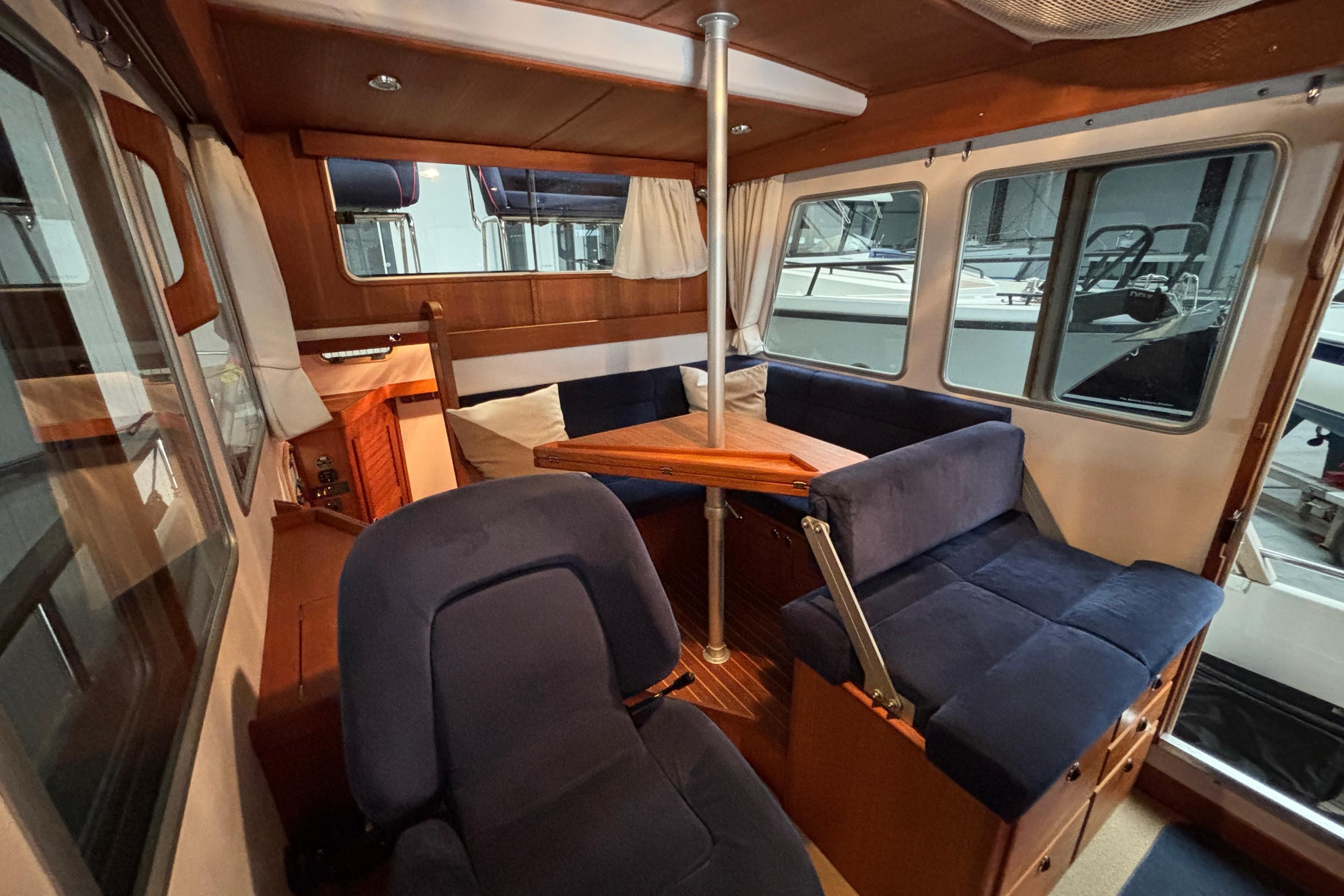 Interior of 2009 Targa 31 boat with blue seating and wooden accents.