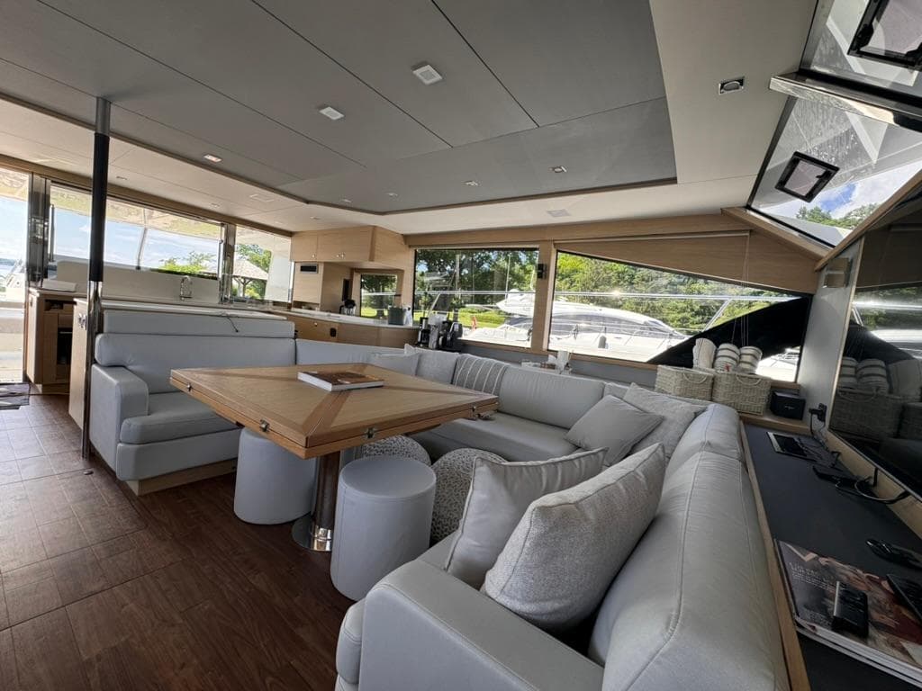 Luxurious interior of 2024 Aquila 54 Yacht with modern seating and large windows.