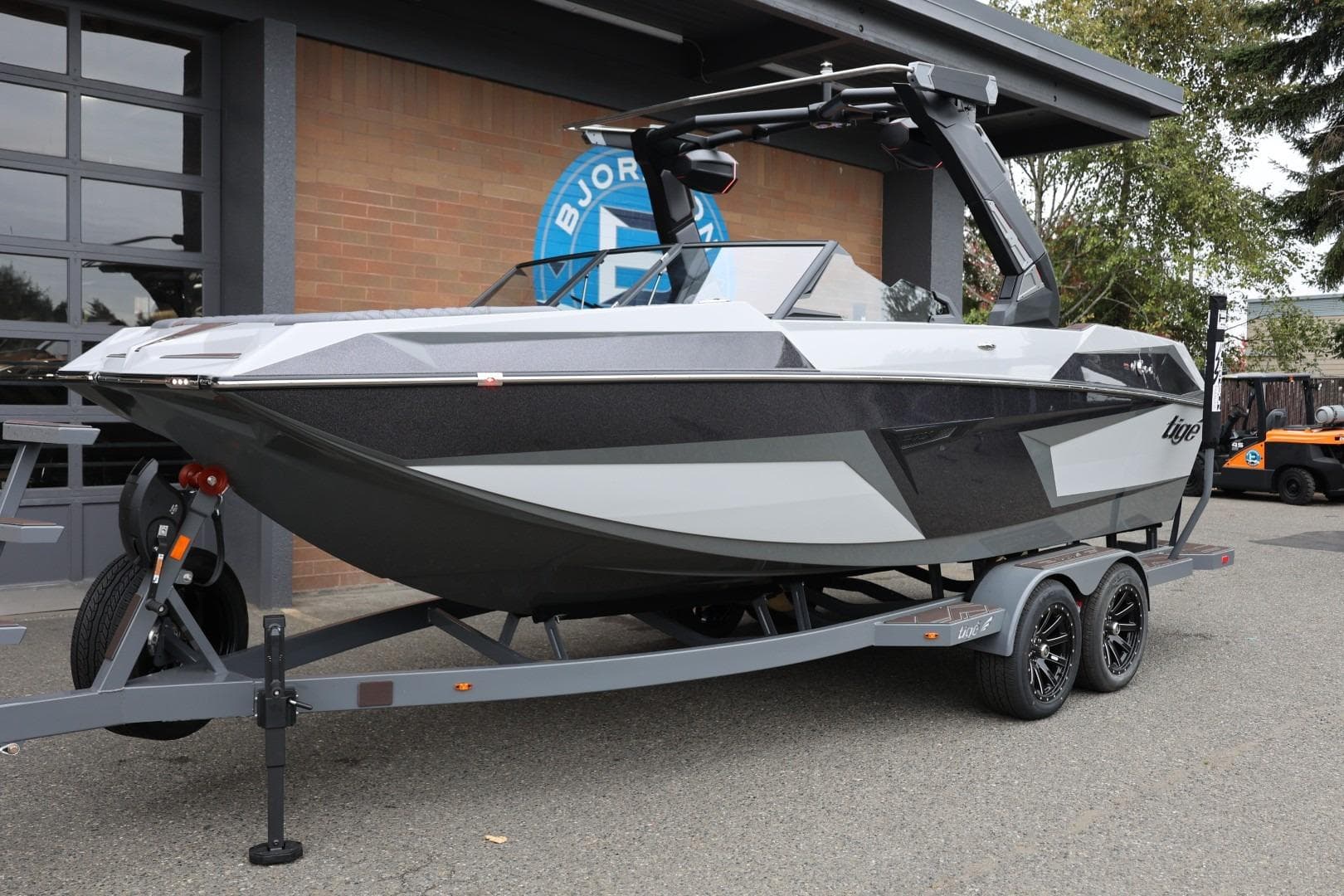 2026 Tigé 22RZX boat on trailer, sleek design, parked outdoors.