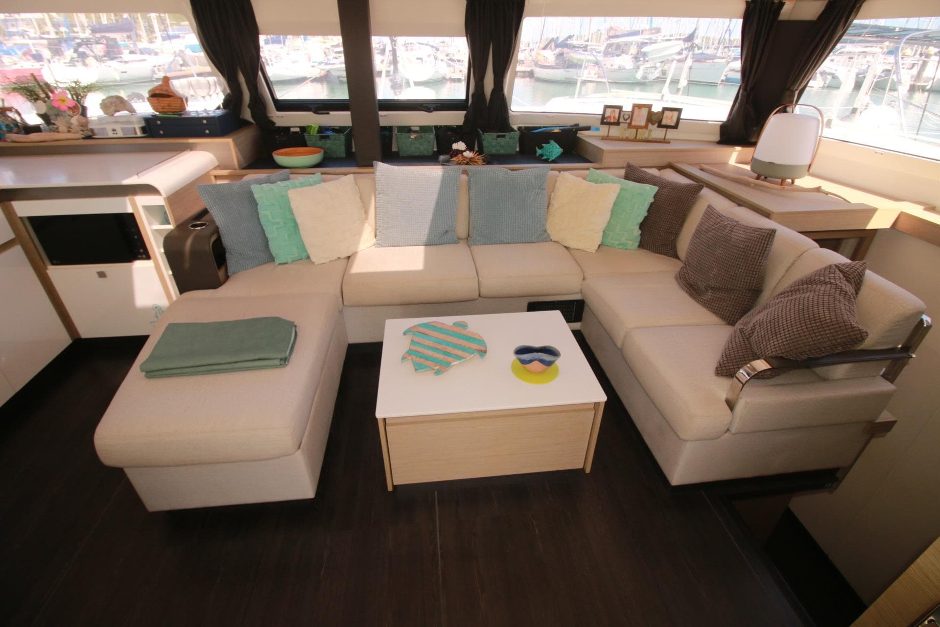 Luxurious interior of 2022 Fountaine Pajot Elba 45 Catamaran with cozy seating and decor.