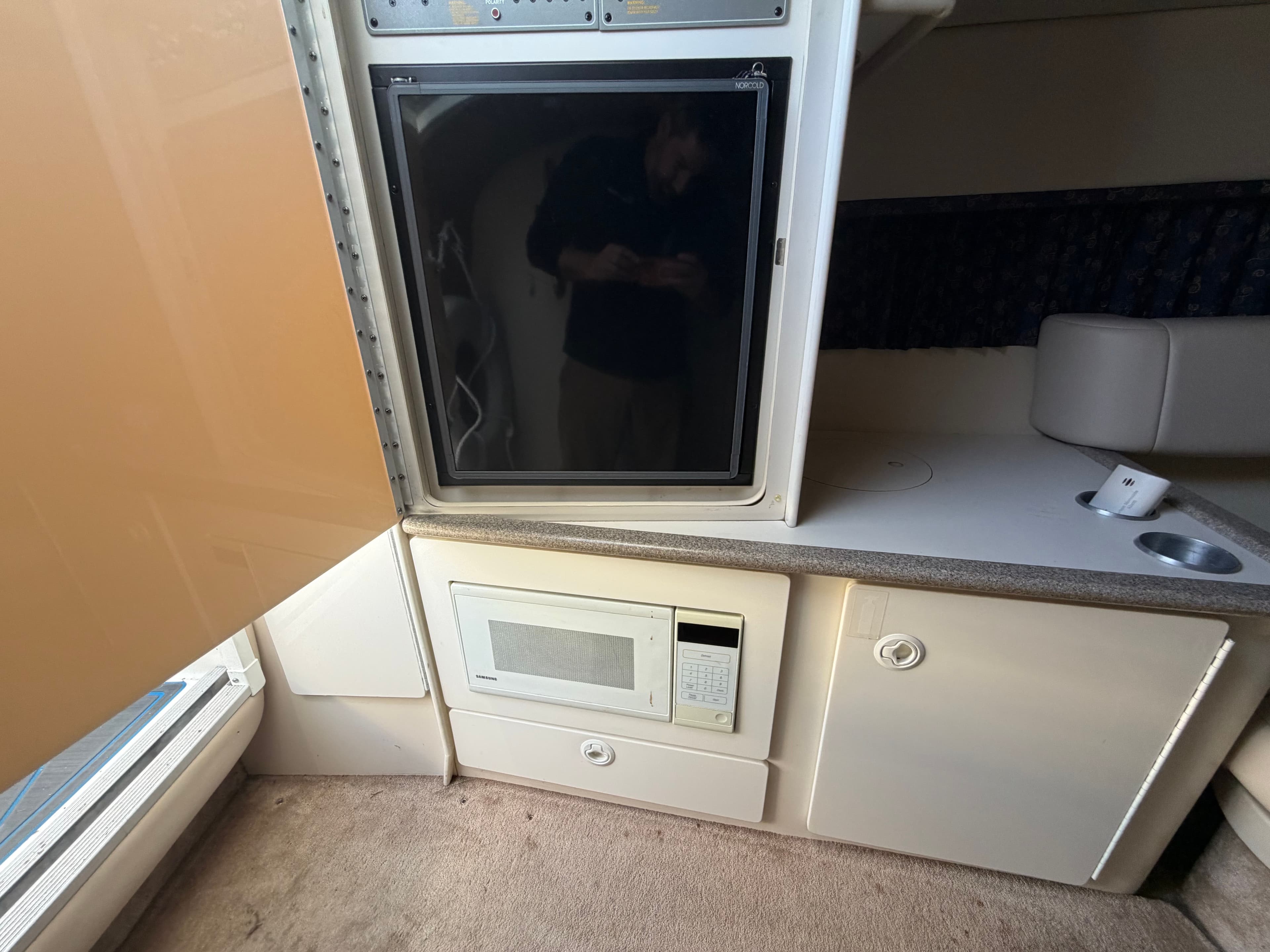 Interior of a 2002 Formula 330 Sun Sport with fridge and microwave.