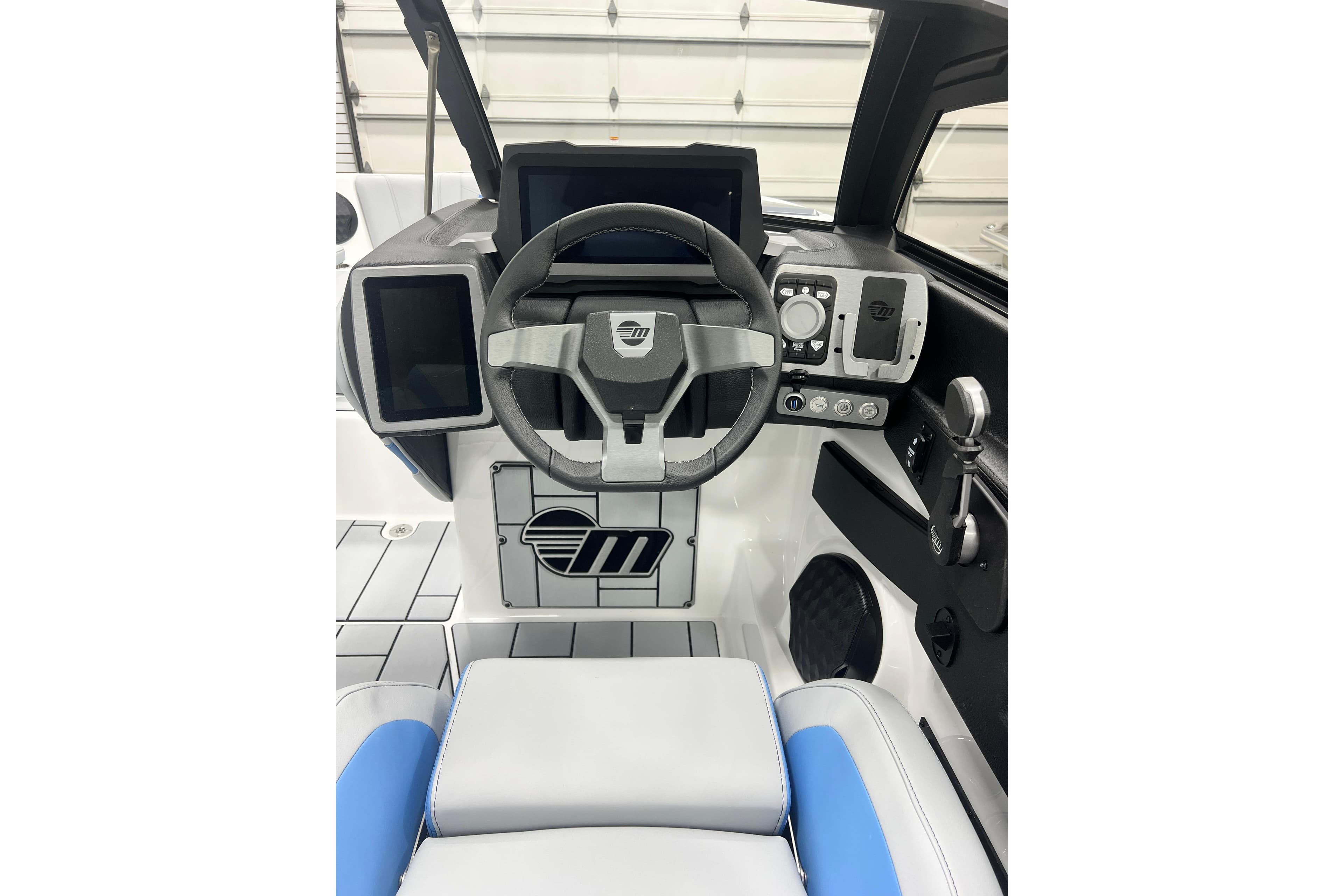 2024 Malibu Wakesetter 24 MXZ boat dashboard with modern controls and steering wheel.