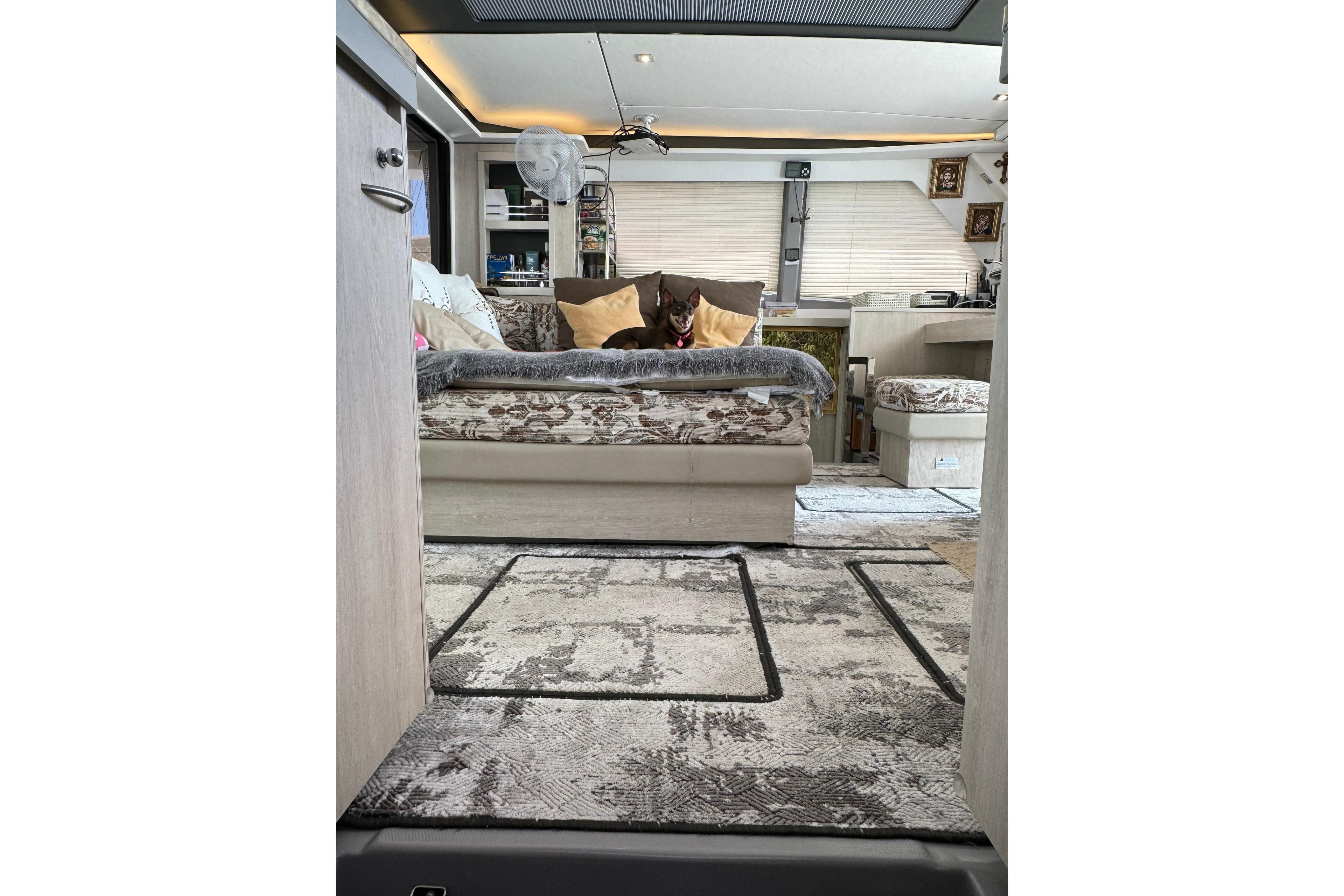 Interior of a 2019 Leopard 45 catamaran with cozy seating and decorative pillows.