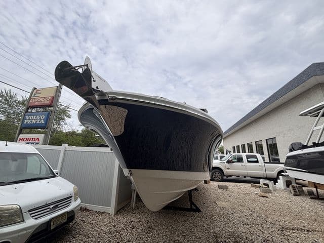 Edgewater 262CX Dual Console boat, 2026 model, parked on gravel lot.