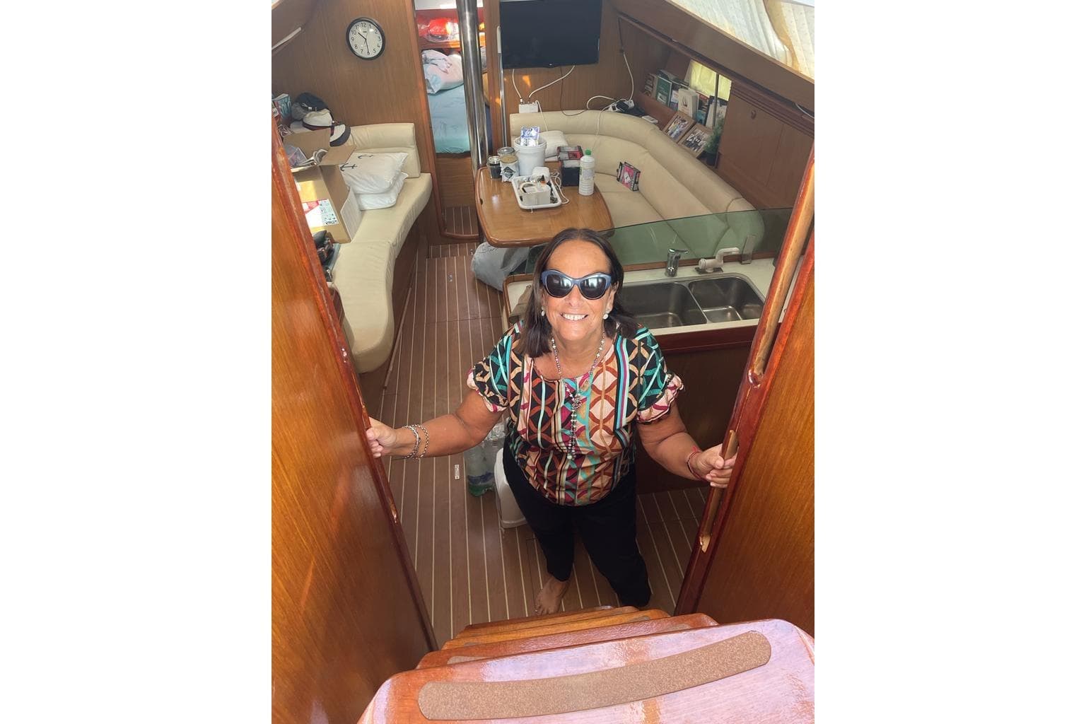 Woman smiling inside 2007 Jeanneau Sun Odyssey 39 DS yacht interior.