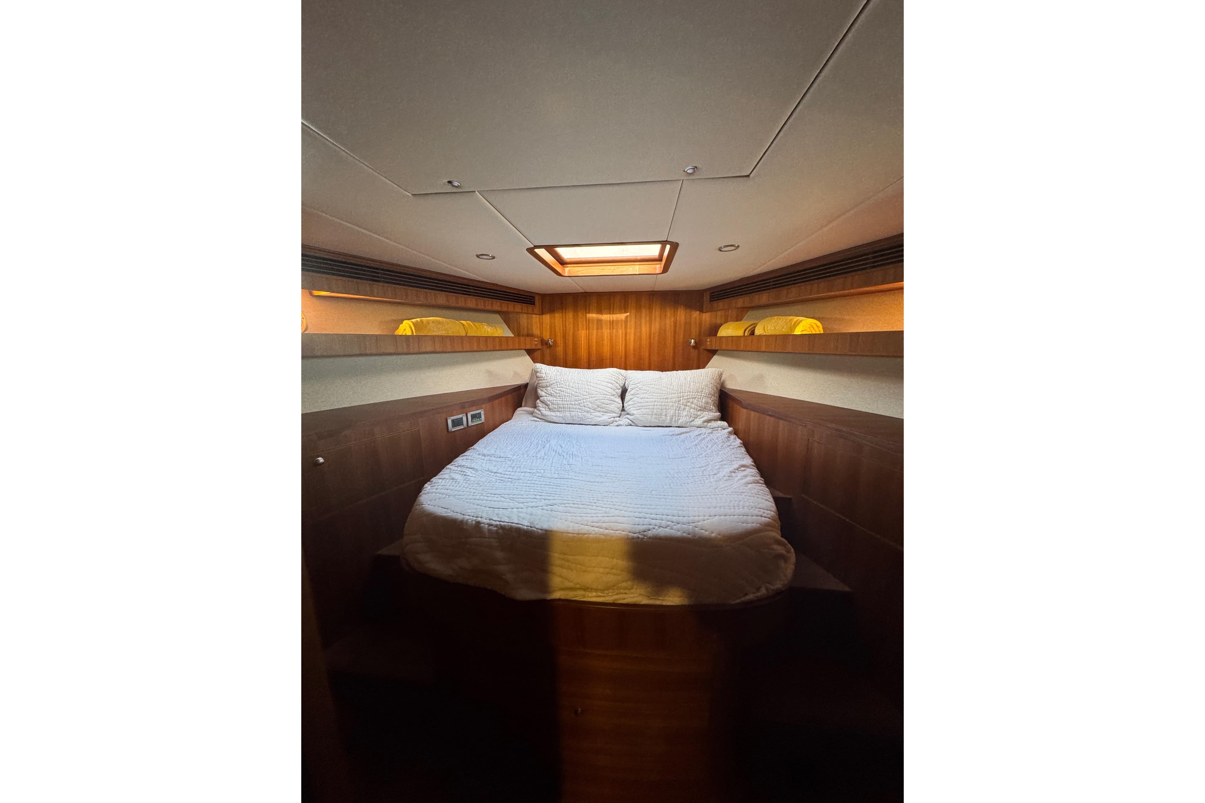 Luxurious cabin interior of 2023 Outer Reef Yachts 670 Azure Motoryacht, featuring cozy bedding.