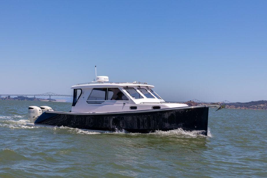 True North 34 boat cruising on water, 2020 model, clear sky background.