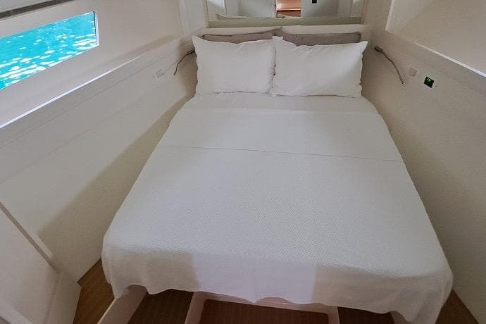 Cozy cabin interior of 2016 Itama 45 yacht with a neatly made bed.