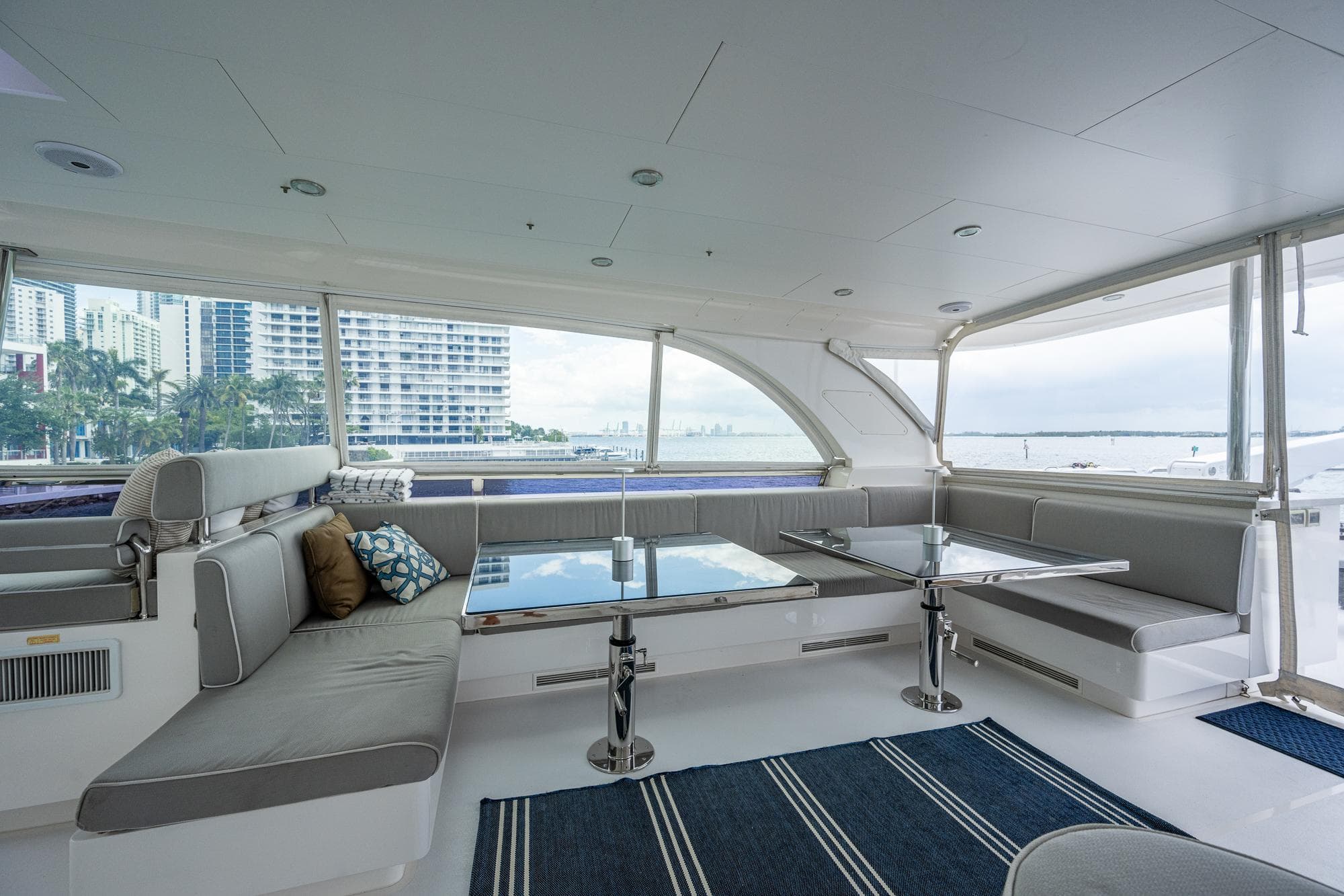 Luxurious interior of 2016 Horizon E88 yacht with cityscape view.