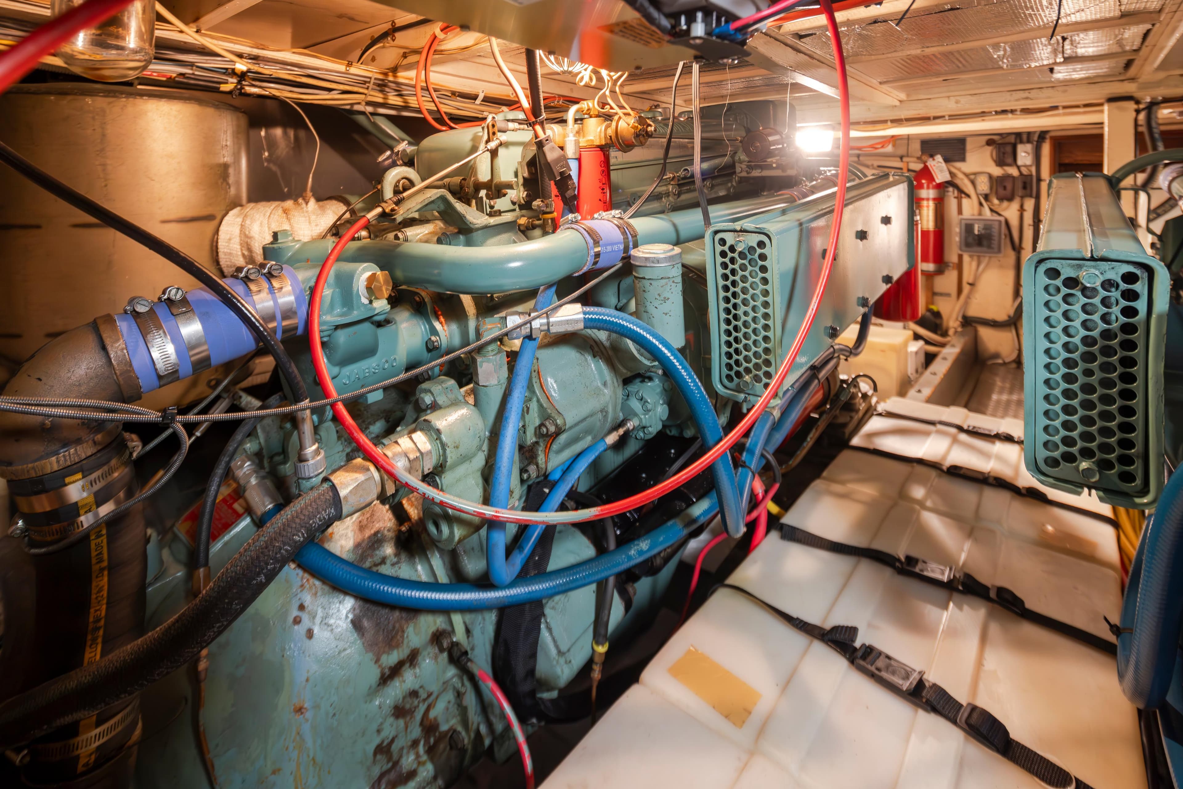 Engine room of a 1965 Stephens Flushdeck boat with complex wiring.