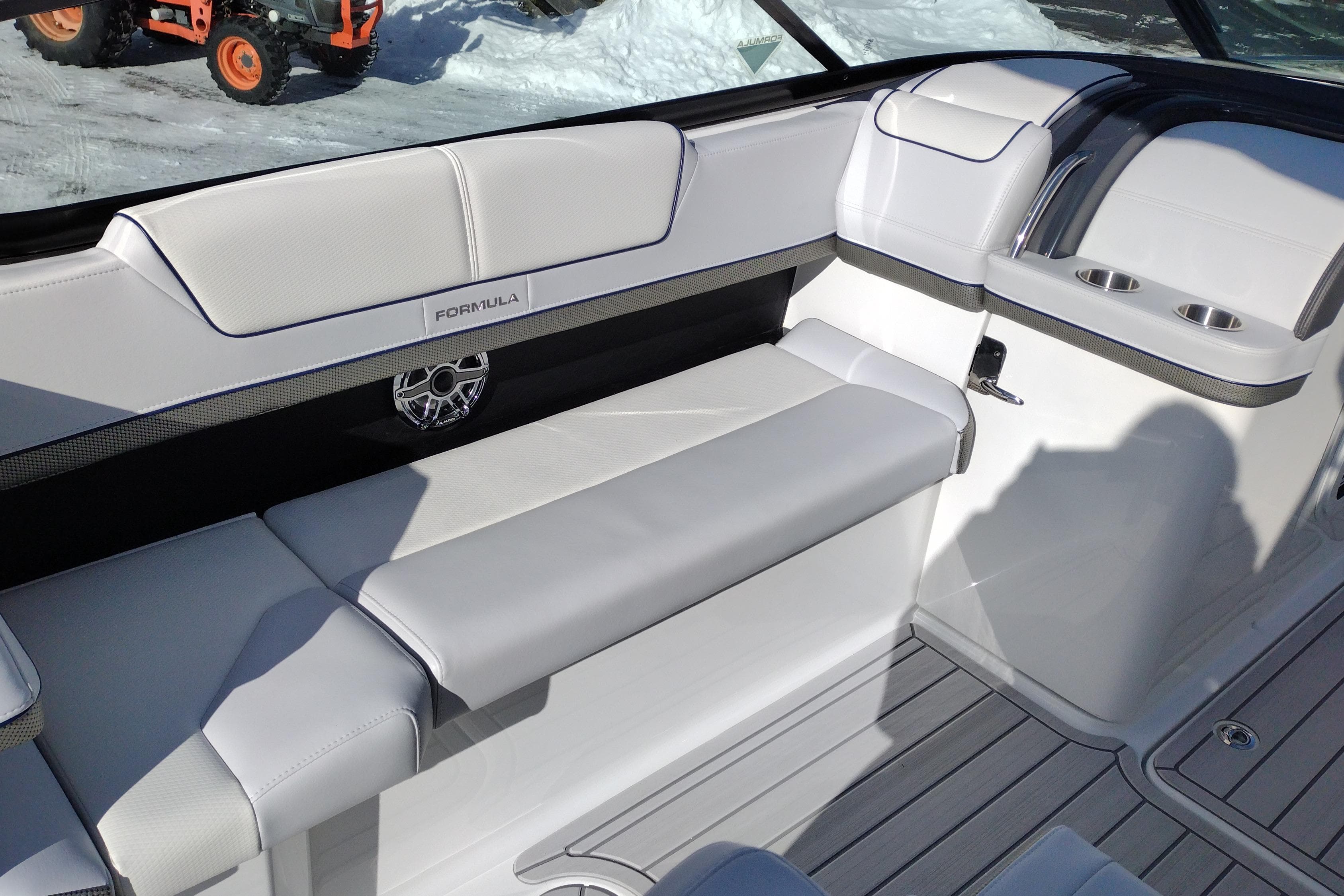2026 Formula 310 Bowrider interior with sleek white seating and cup holders.