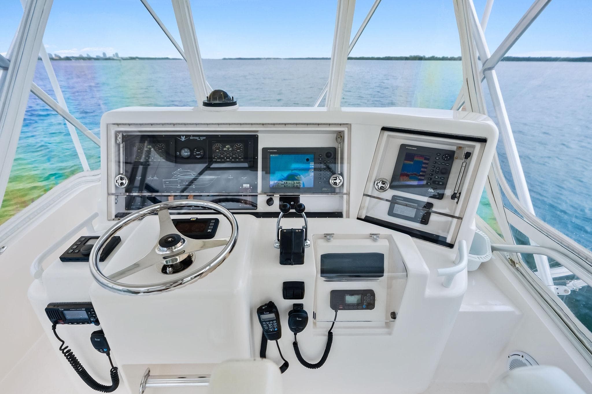 2006 Bertram 39 Convertible helm with navigation equipment and ocean view.