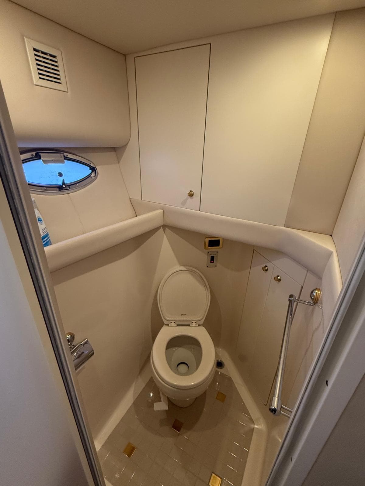 Bathroom interior of 2001 Sea Ray 540 Cockpit Motor Yacht, featuring a compact toilet.