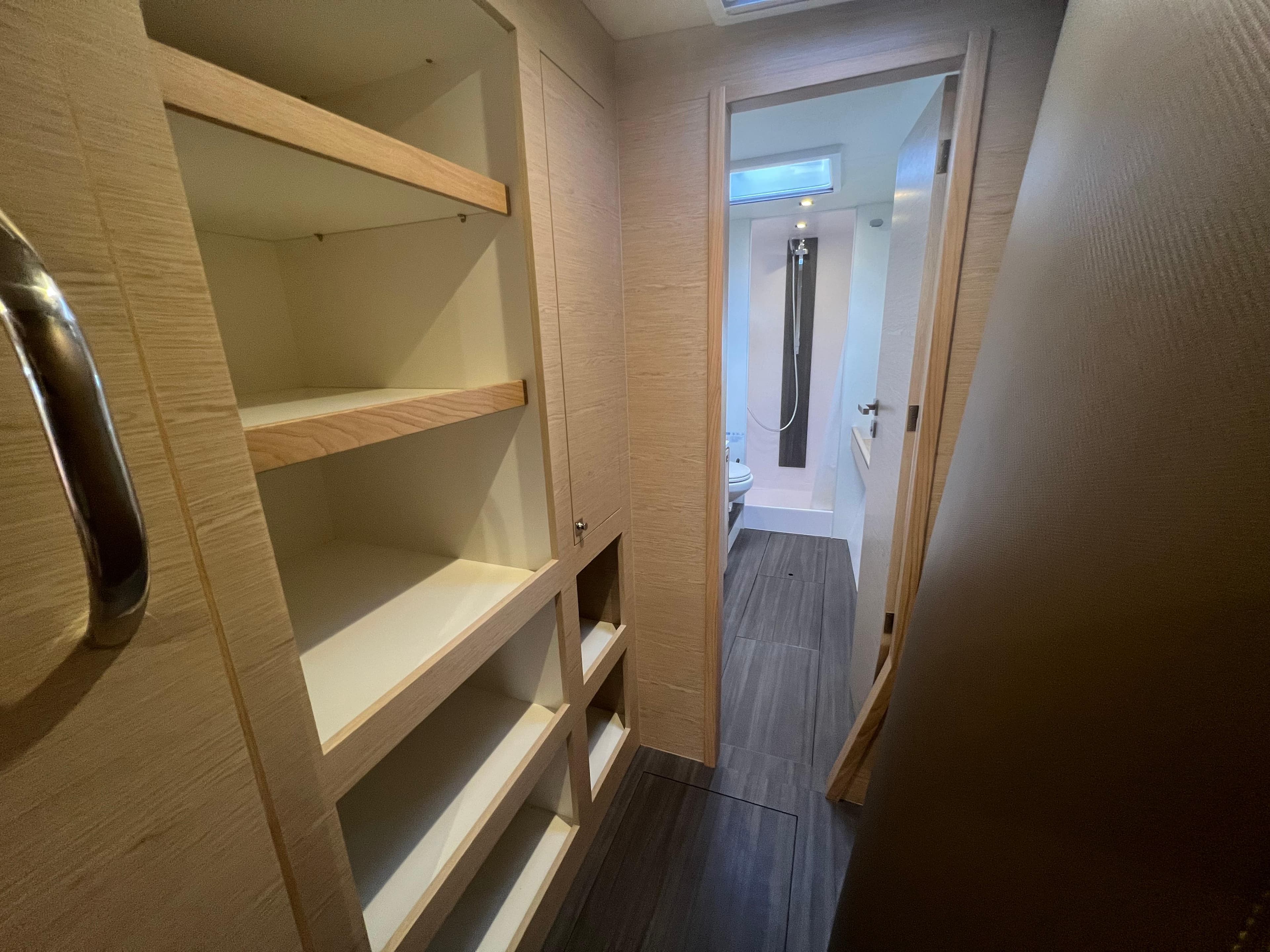 2024 Outremer 45 interior hallway with shelving and bathroom view.