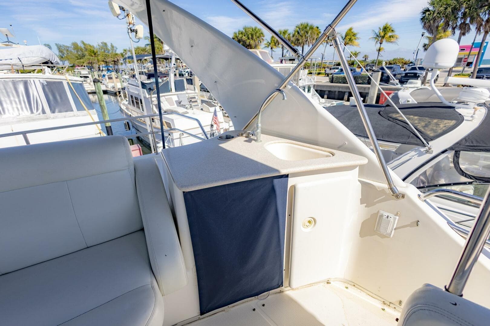 2001 Silverton 410 Sport Bridge yacht interior with seating and sink, docked at marina.