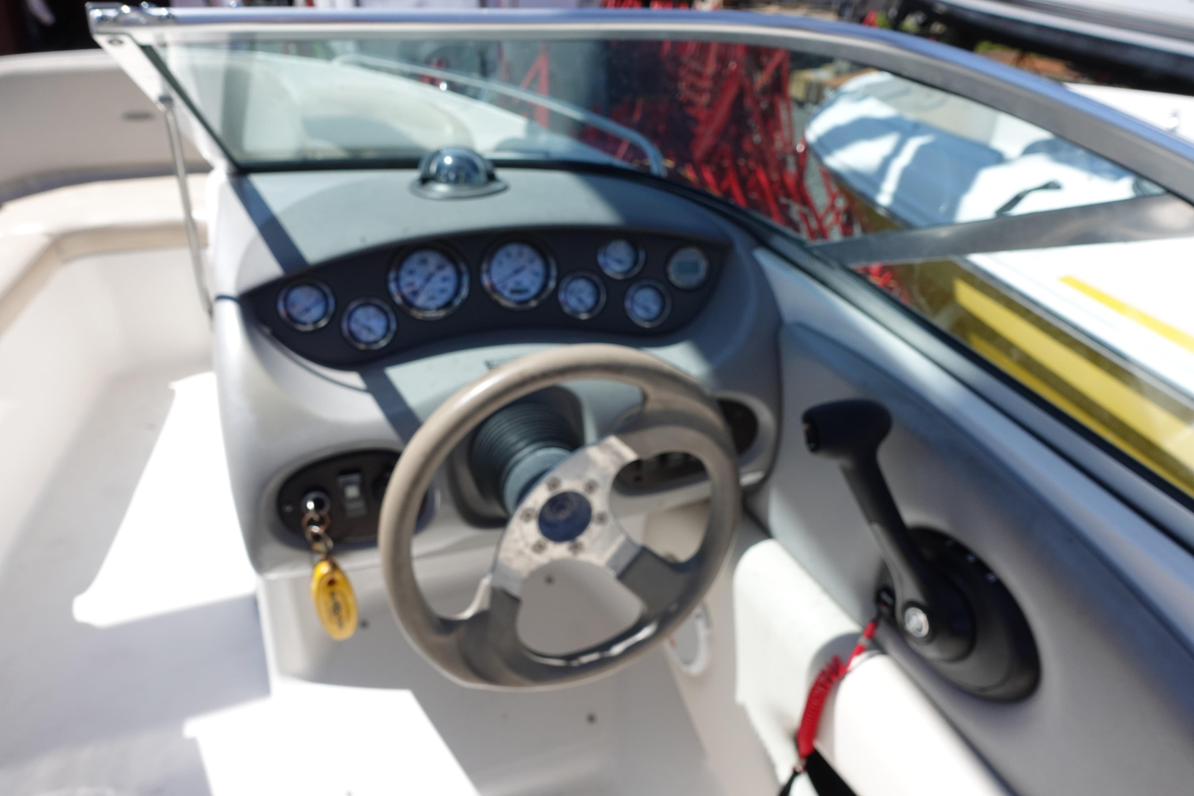 2004 Chaparral 210 SSi boat dashboard with steering wheel and gauges.