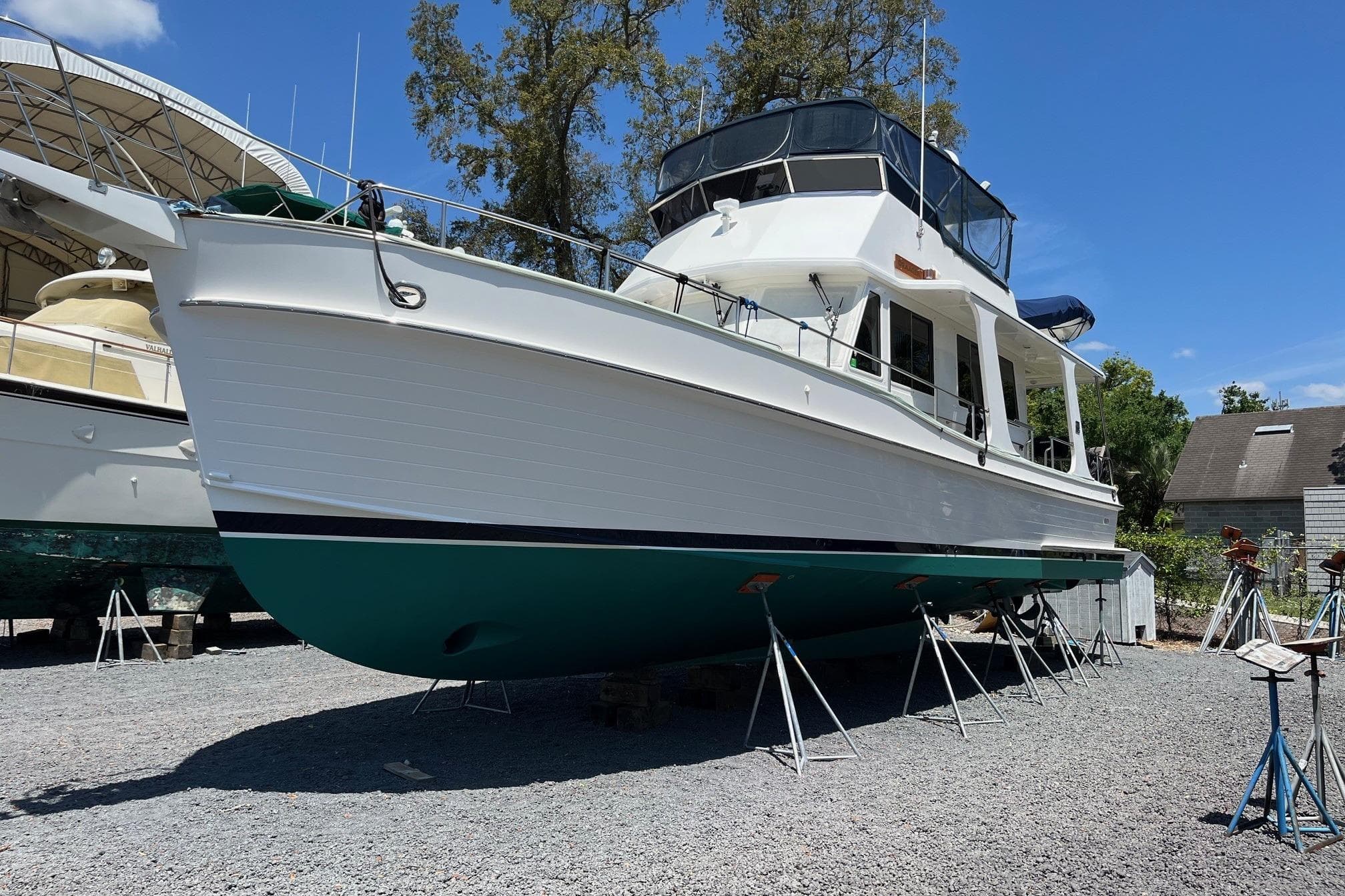 2006 Grand Banks 47 Heritage EU yacht on stands, displayed outdoors under clear blue sky.