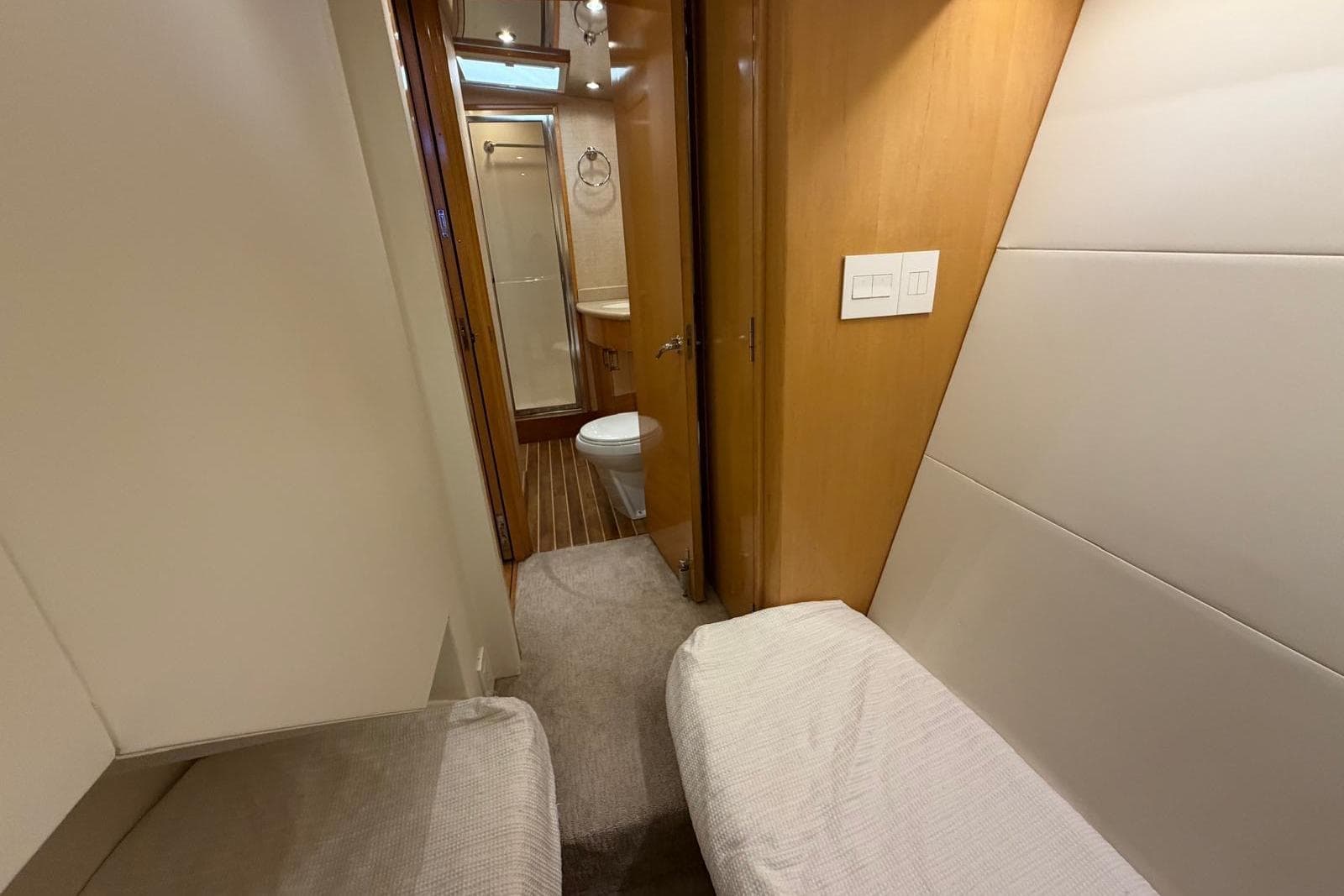 Interior of 2003 Hatteras 54 Convertible yacht with cozy cabin and bathroom.