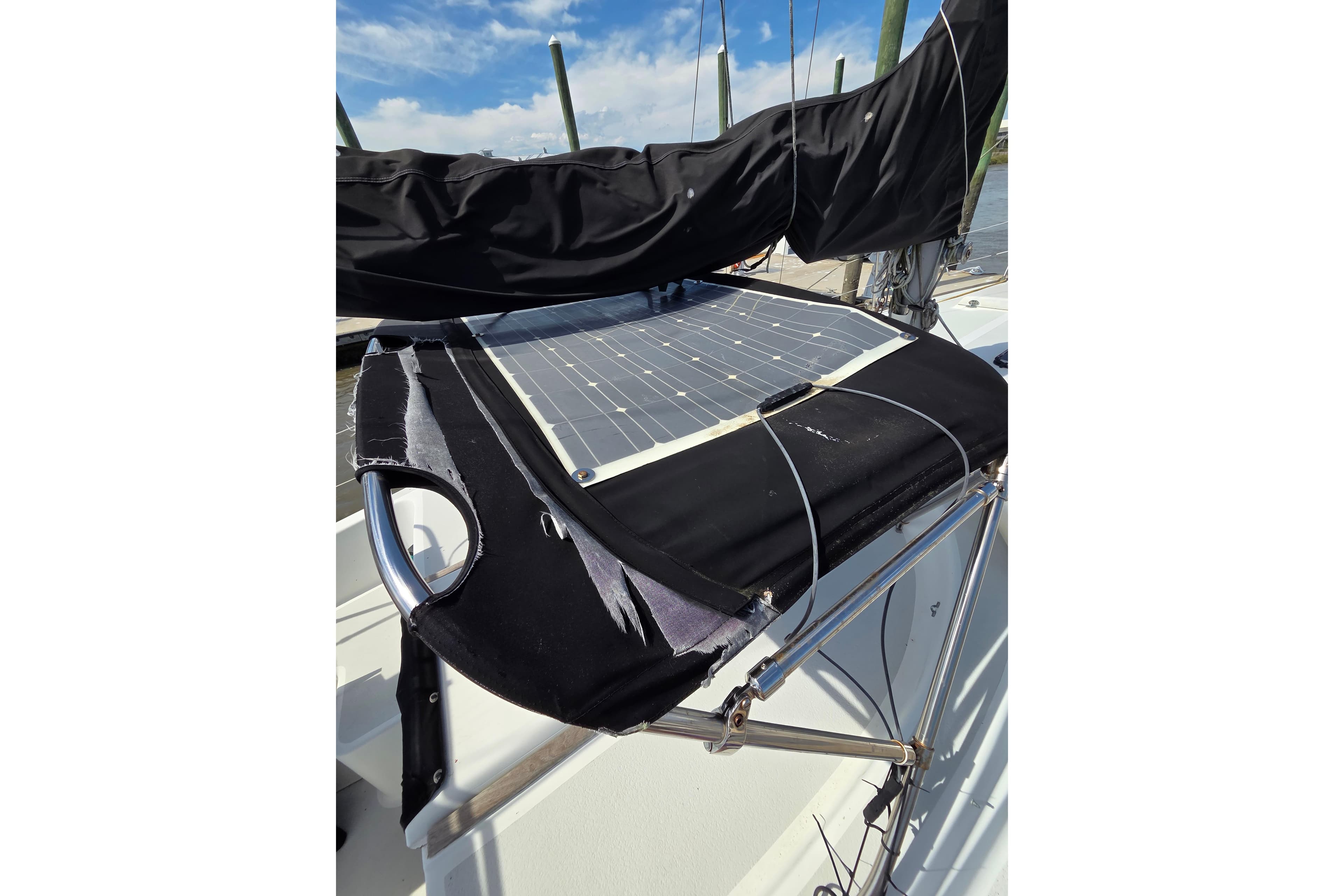 1976 Morgan 33 Out Island sailboat with solar panel and black cover.