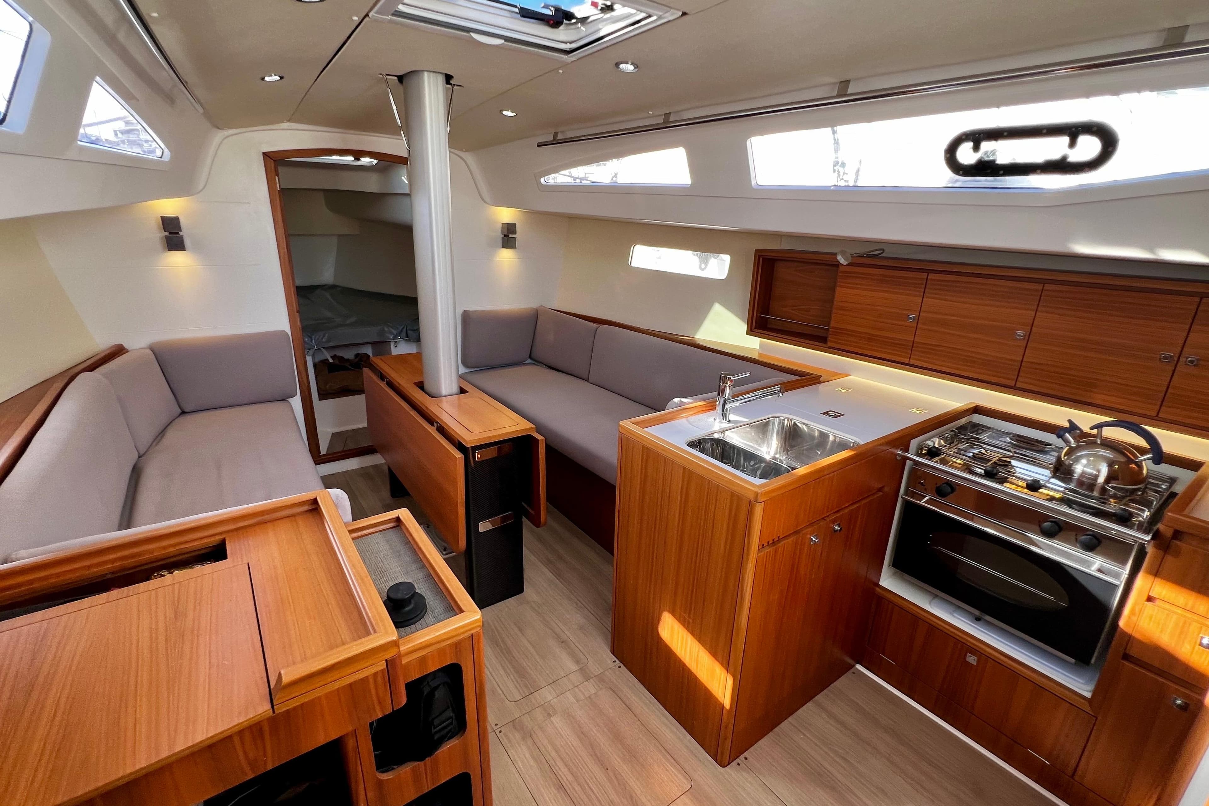 2018 J-Composites J/112E yacht interior with modern kitchen and cozy seating area.