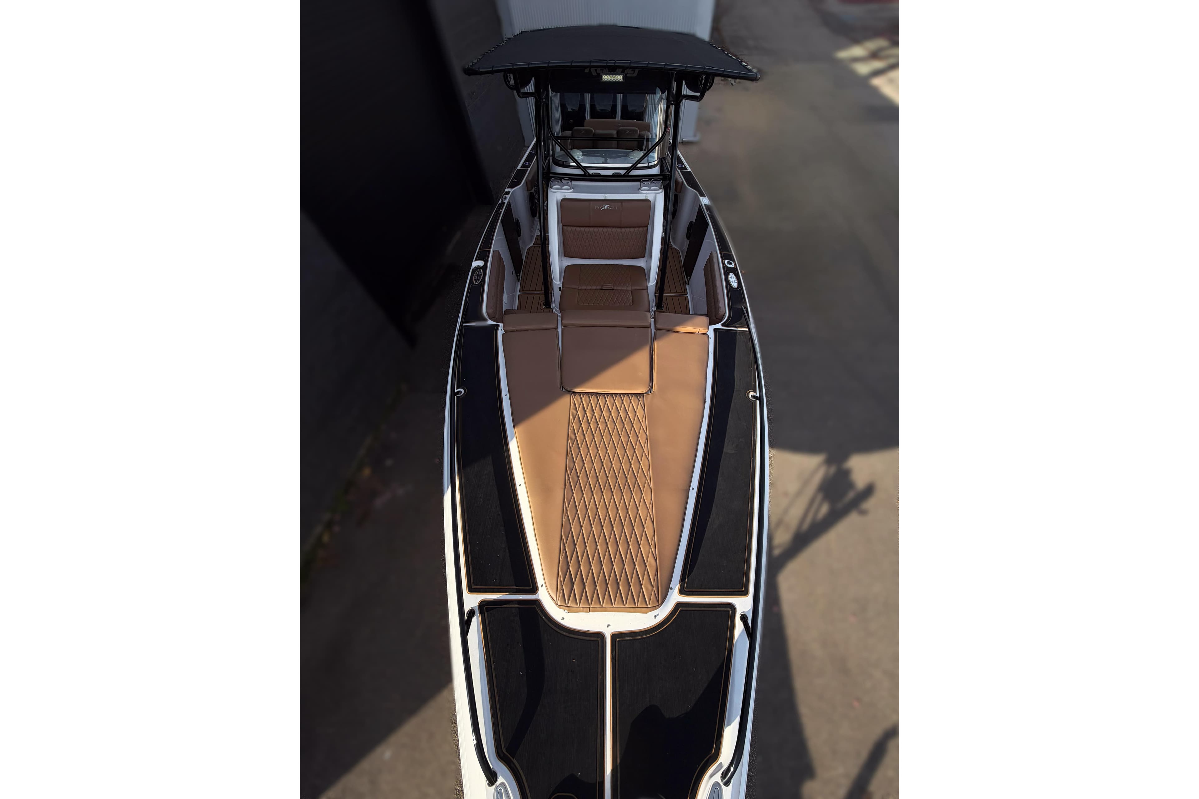 2006 Donzi 35 ZF Cuddy boat with sleek black and brown design, top view.