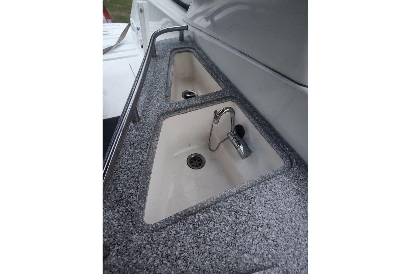 2009 Fountain 38 Express Cruiser sink area with dual basins and chrome faucet.