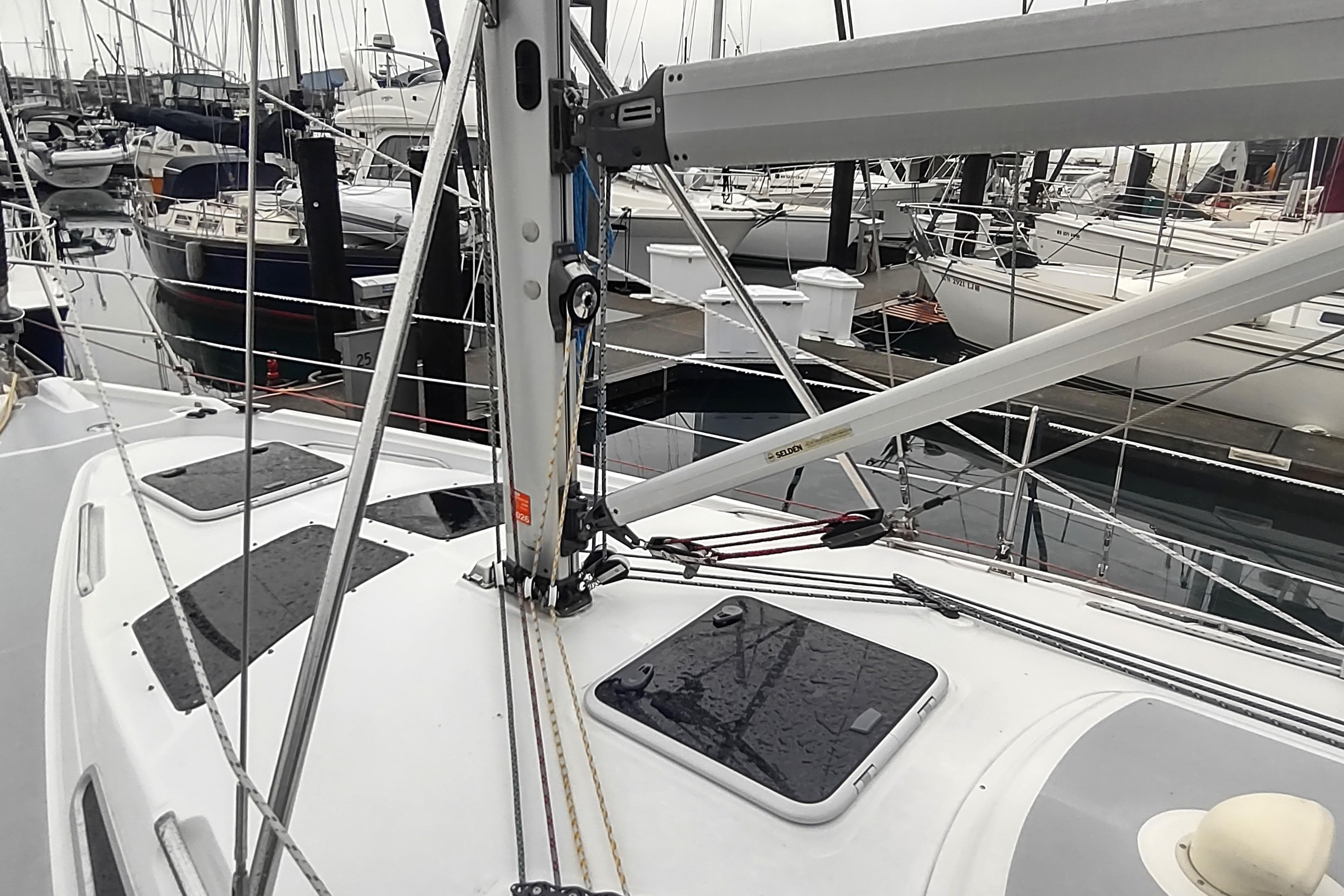 2003 Hunter 356 sailboat deck with rigging in a marina setting.