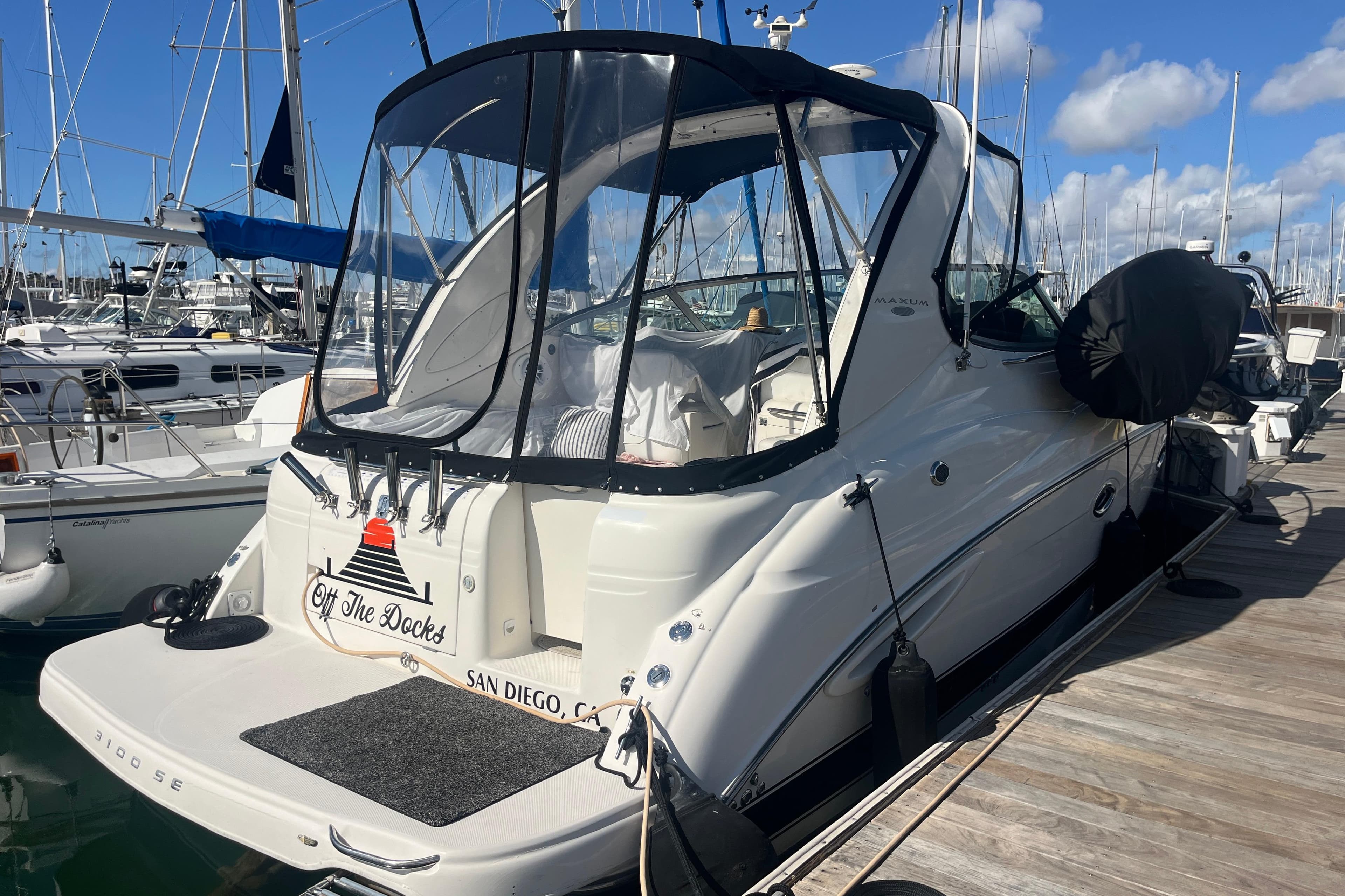 2007 Maxum 3100 SE boat docked in San Diego marina under clear skies.