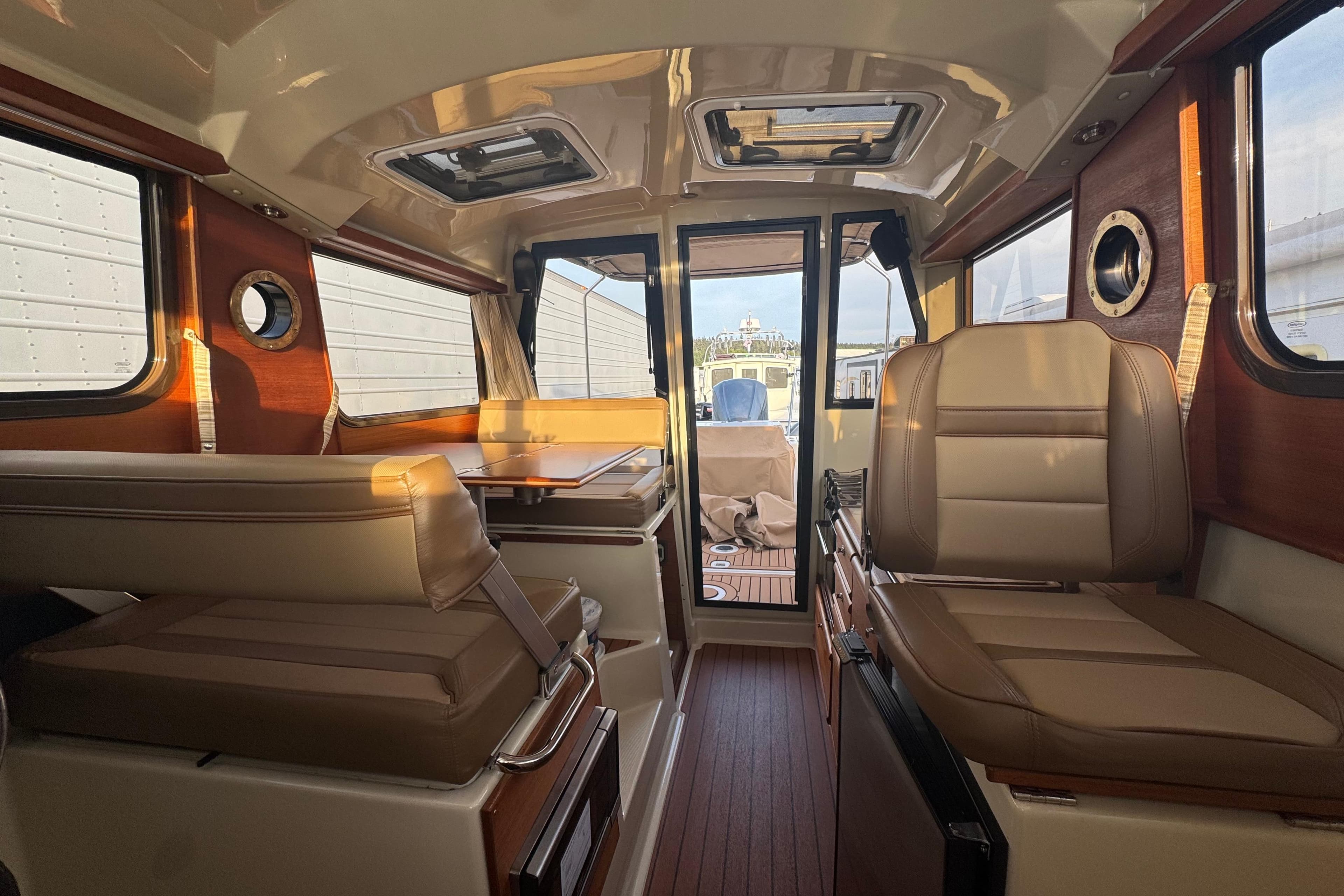 Interior of 2020 Ranger Tugs R-27 boat with leather seating and wood accents.