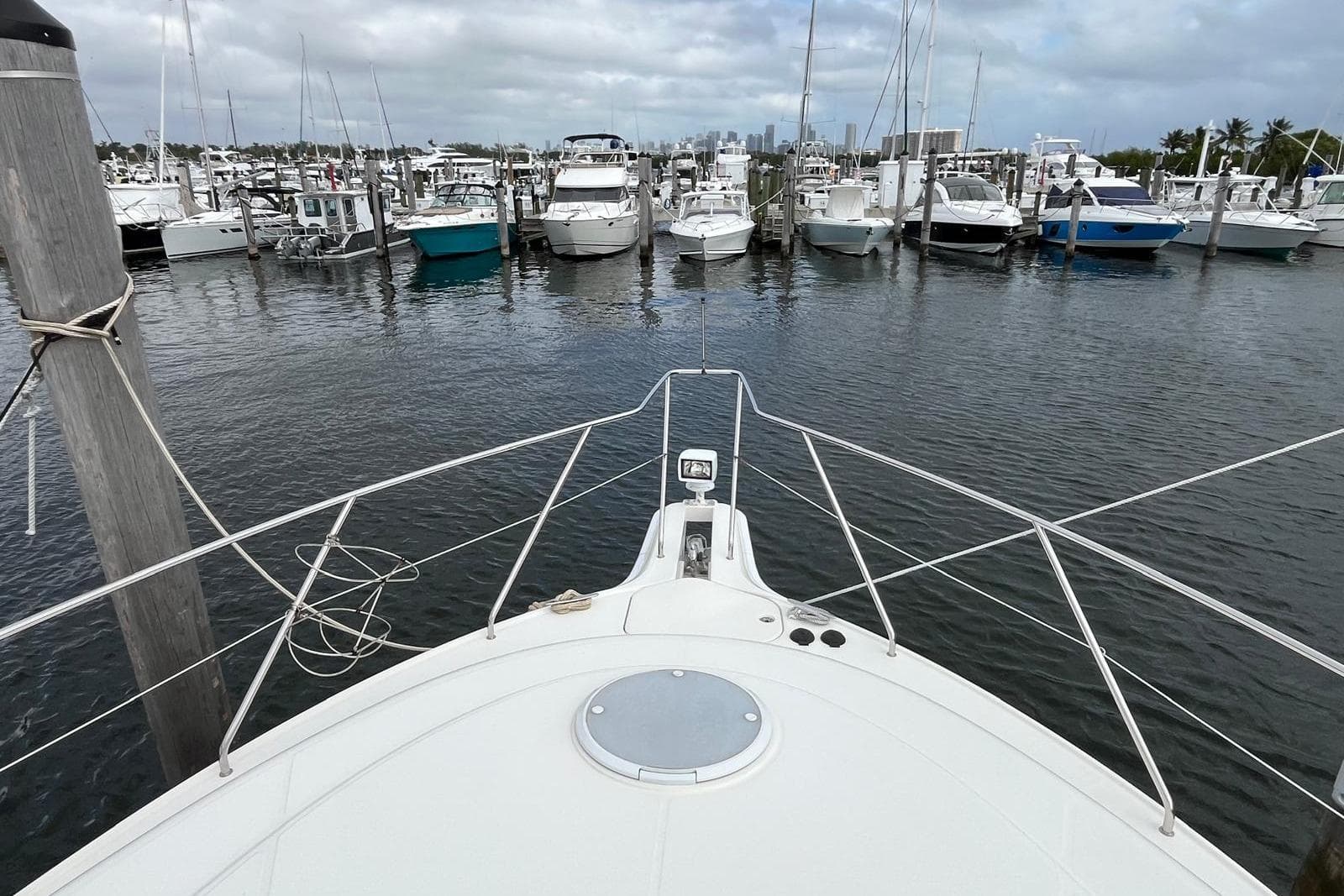 Bow view of 2005 Silverton 34 Convertible yacht docked in a marina.