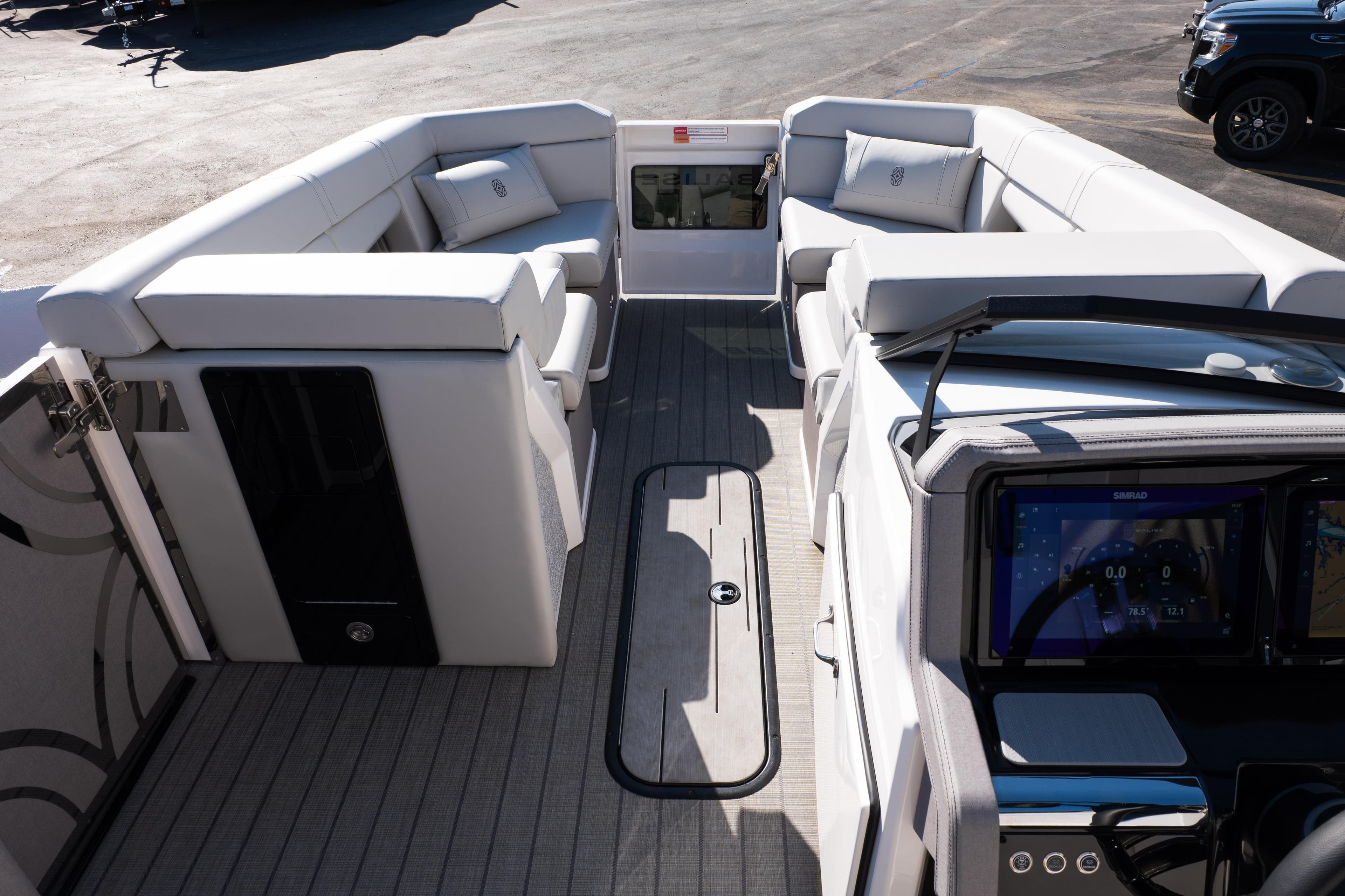 Luxurious interior of 2025 Balise Helix 24C boat with modern seating and navigation system.