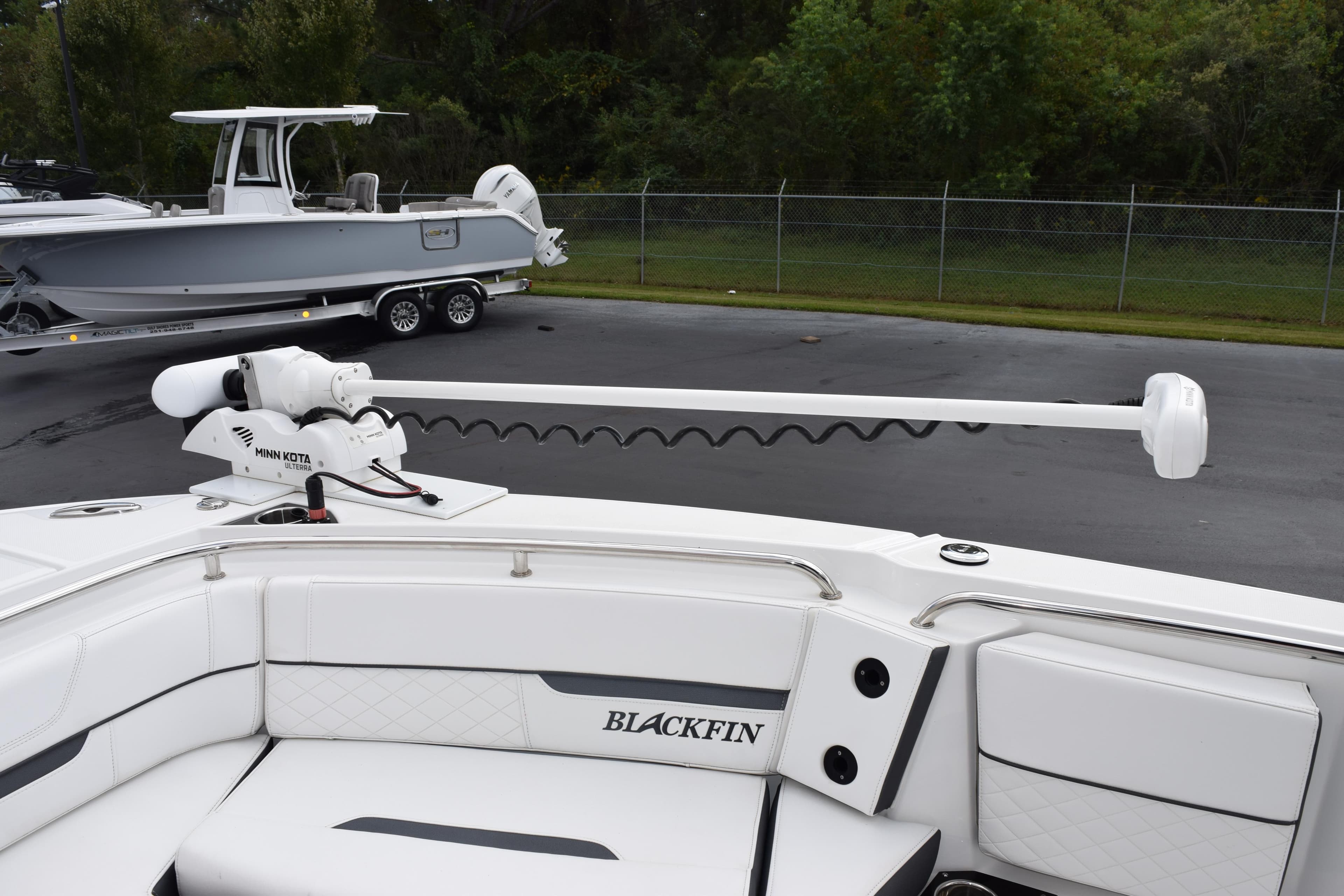 2023 Blackfin 252 CC boat with Minn Kota trolling motor, parked on a trailer.