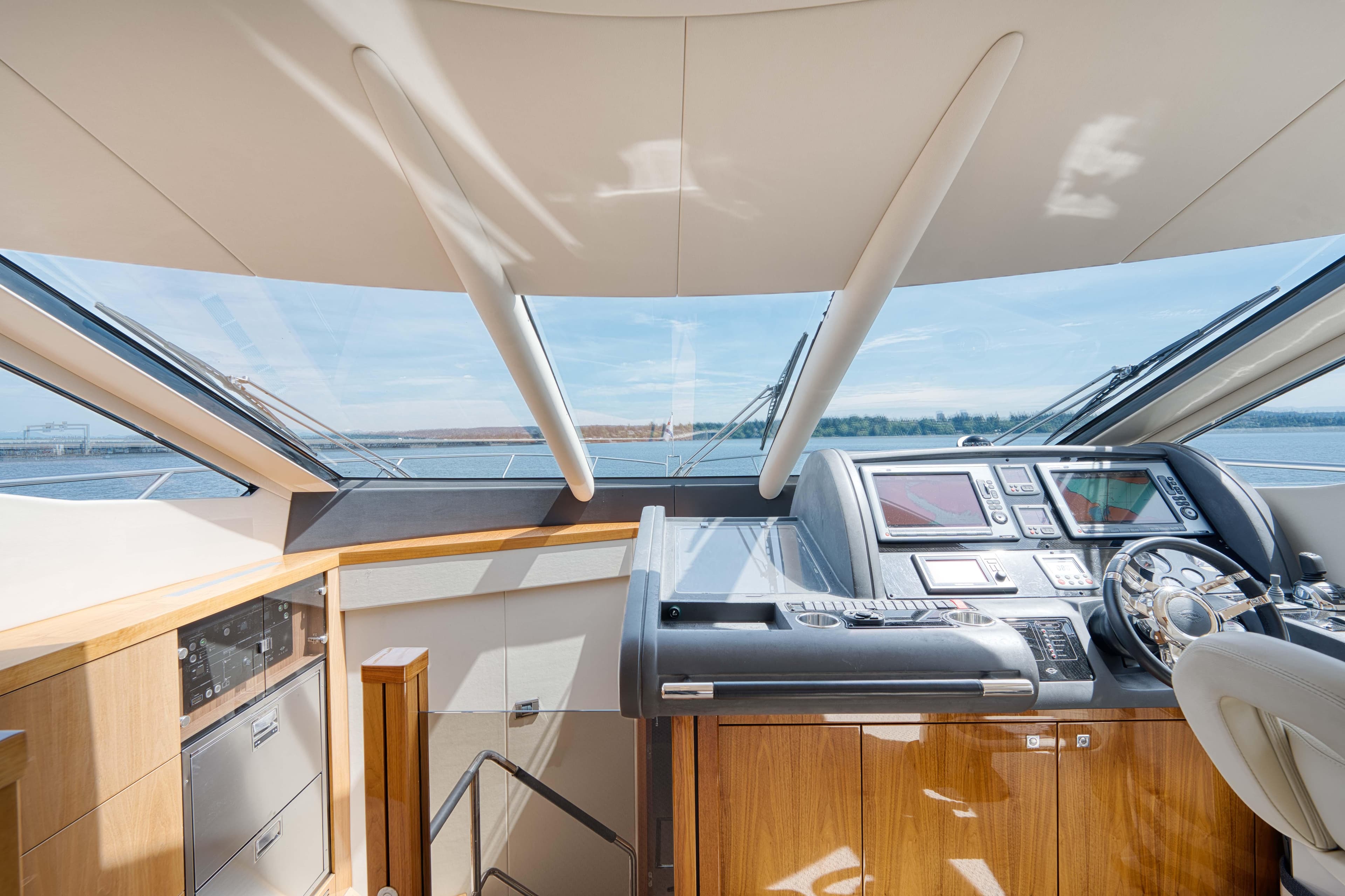 Interior helm of 2012 Sunseeker Manhattan 63 yacht with modern navigation equipment.