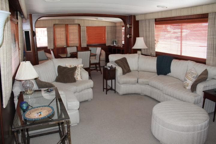 Luxurious interior of 1985 Hatteras 58 Motor Yacht with plush seating and elegant decor.
