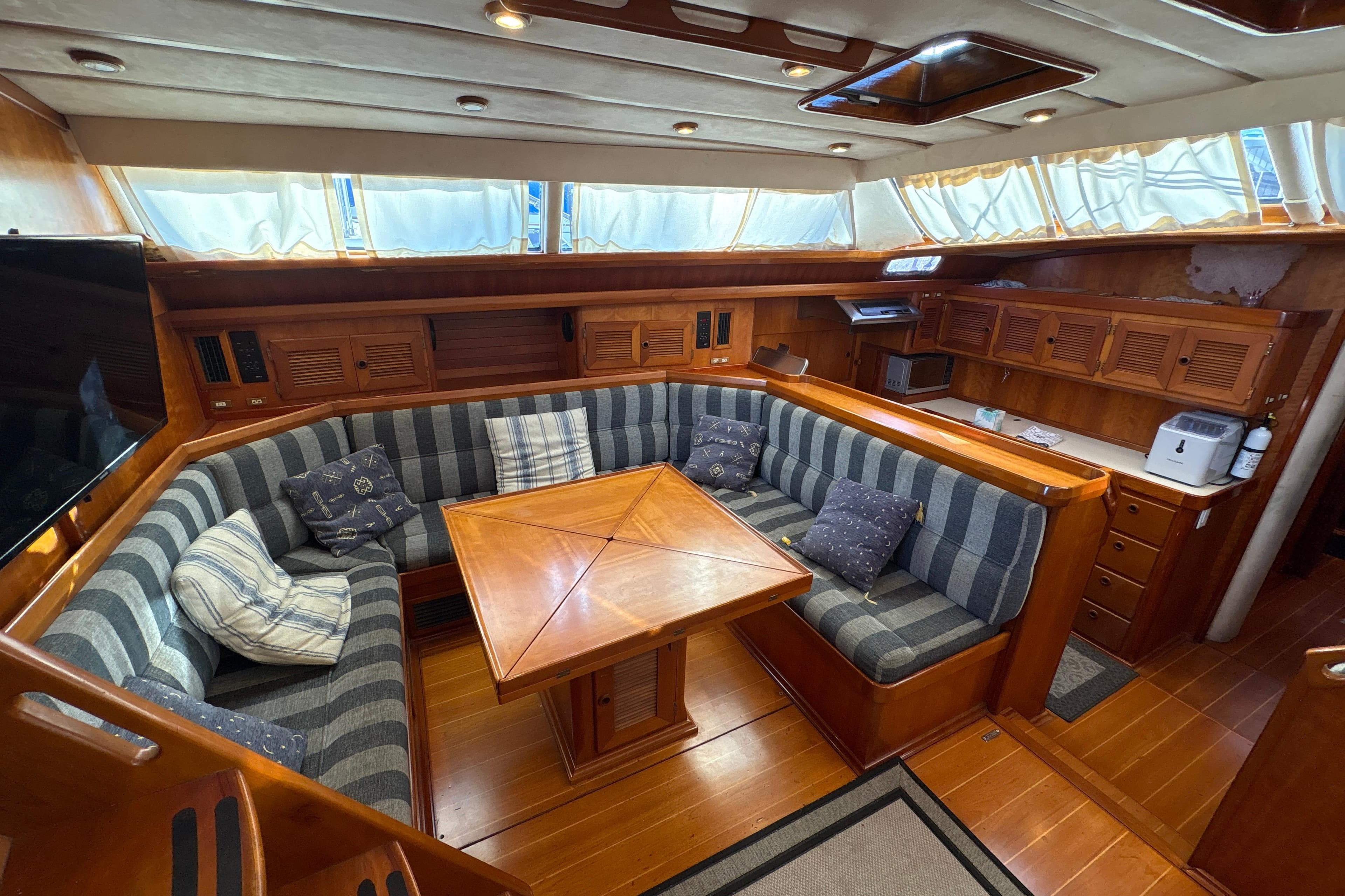 Luxurious interior of 2001 North Wind 56 yacht with cozy seating and wooden finishes.
